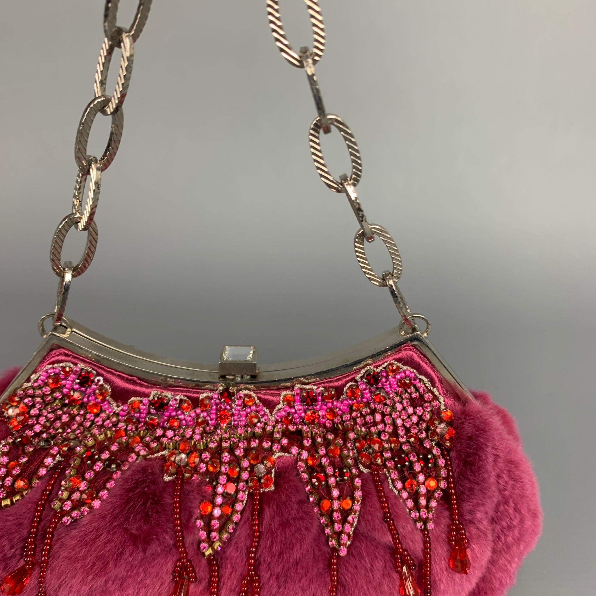 BADGLEY MISCHKA handbag comes in a purple fur with rhinestone details featuring silver tone hardware, beaded details, chain handle, and a clasp closure. 

Very Good Pre-Owned Condition.

Measurements:

Length: 7 in.
Width: 3 in.
Height: 4 in.
Drop: