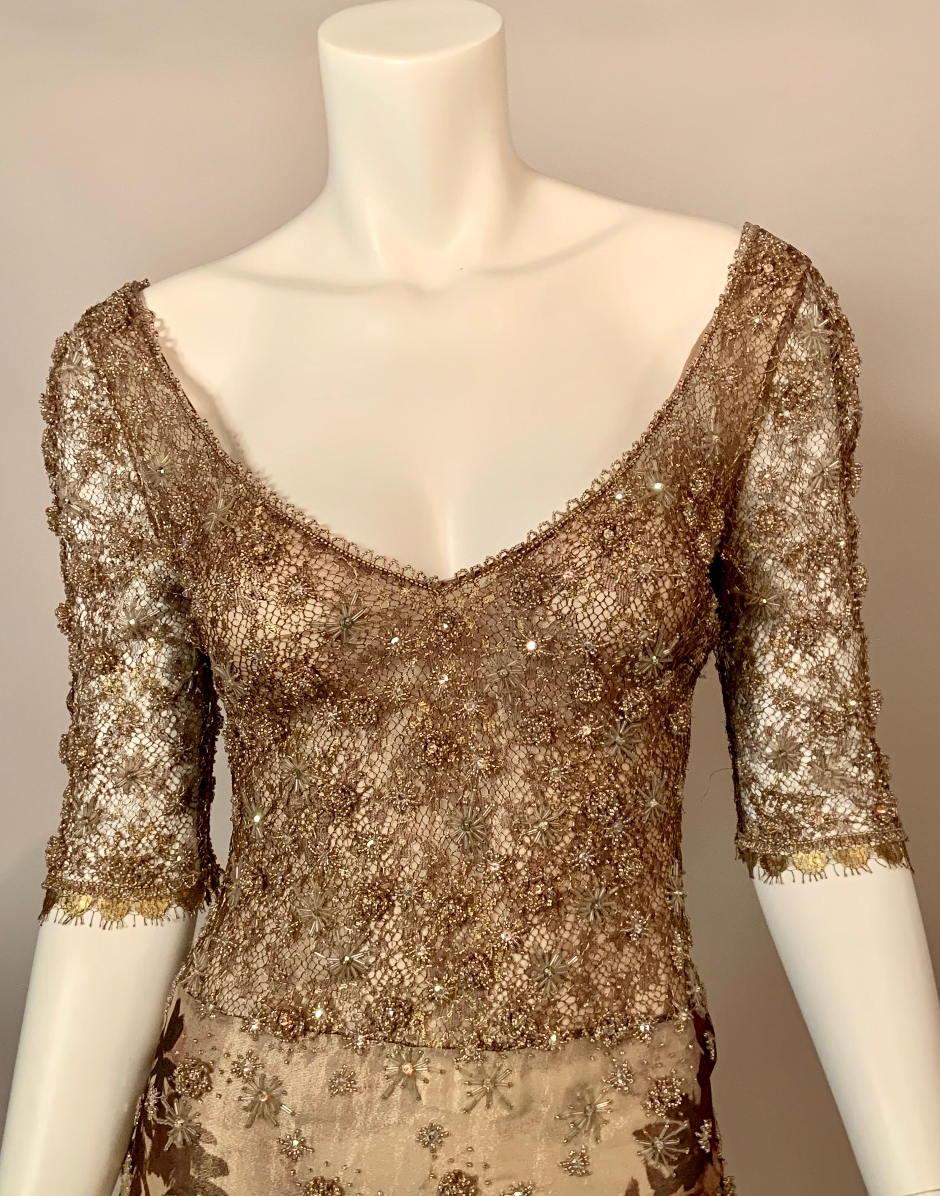 The top of this glamorous dress from Badgley Mischka has starburst beadwork on gold lace. The neckline is edged with caviar beads and the sleeves are trimmed with caviar beads and scalloped gold lace. The long skirt is partially beaded over a fern