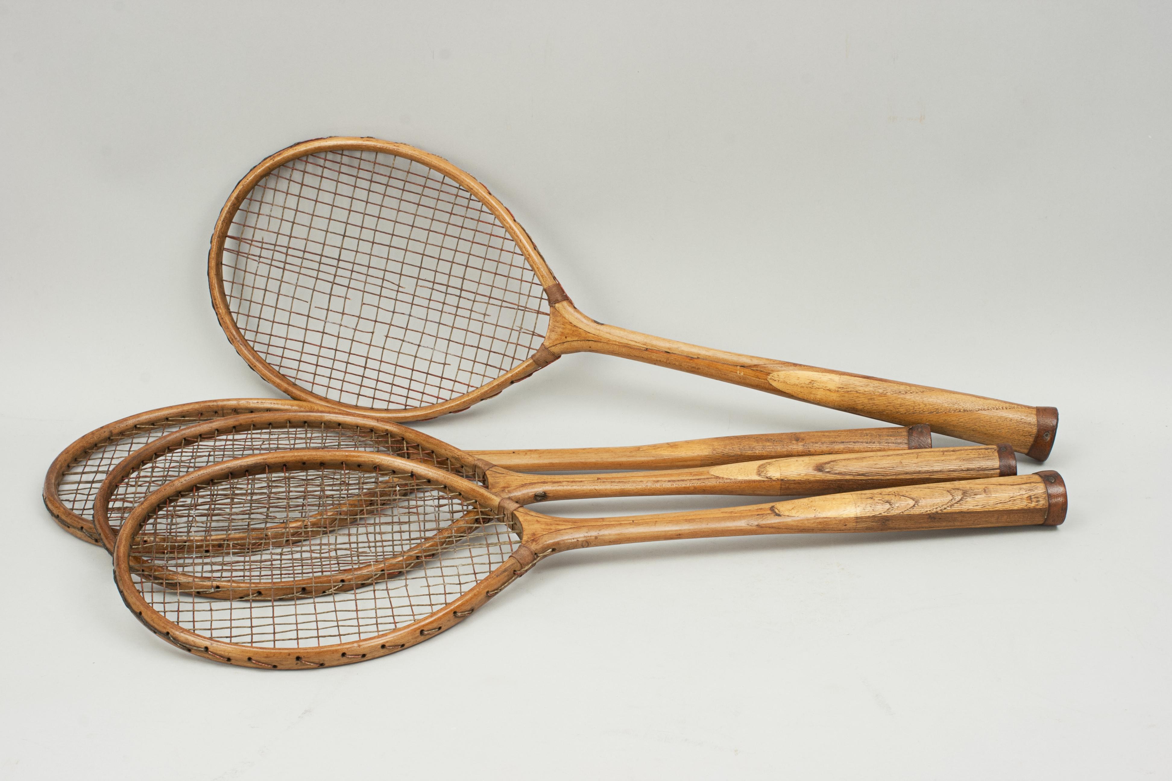 Four Wooden Badminton Rackets.
A nice set of four early 20th century wooden badminton rackets. The racquets have the original red and white stringing and leather butt caps, Although the stringing is damaged they are still very decorative. The maker