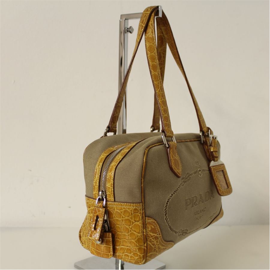 Canvas with crocodile leather inserts Beige and ocher color Double handle Internal pocket with zip Zip closure Cm 28 x 17 x 12 (11.02 x 6.69 x 4.72 inches) Little spot next to the zip closure see pictures
