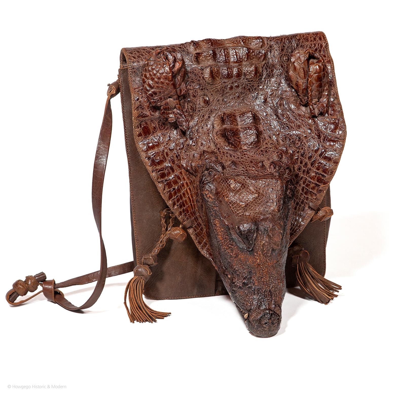 Made from one complete small crocodile skin including head with teeth, hornback and legs into a shoulder, cross or satchel, excluding the tail.  The scales wrapping from front to back with outstanding rich, colouring ,depth and patterning.  The