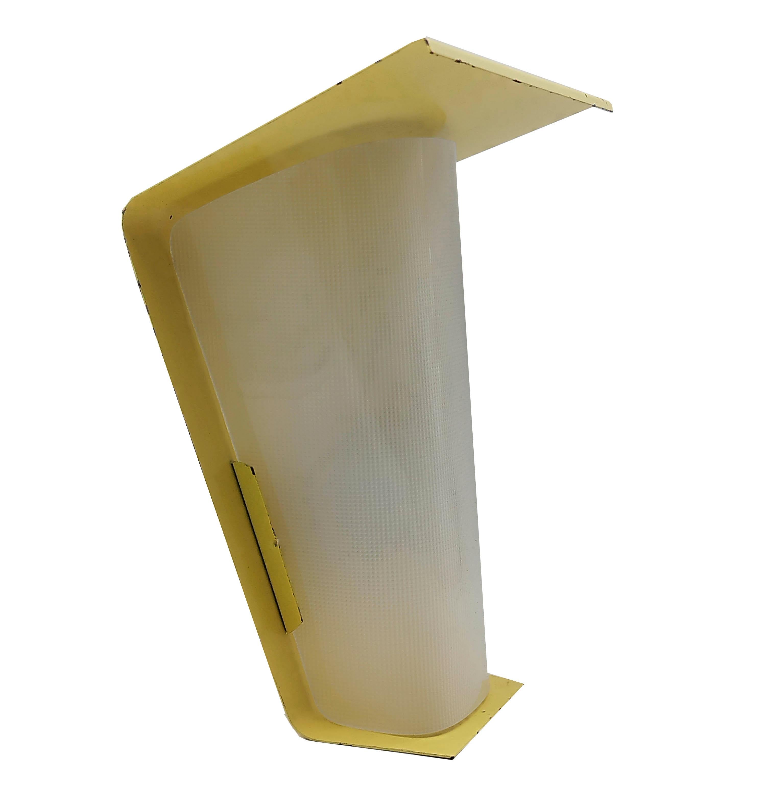 Beautiful and rare outdoor wall sconce from Swiss manufacturer BAG Turgi.
Produced in the 1950s, this modernist design is made of yellow lacquered metal.
The Swiss company BAG Turgi is greatly inspired by Bauhaus theories and offers a functional and