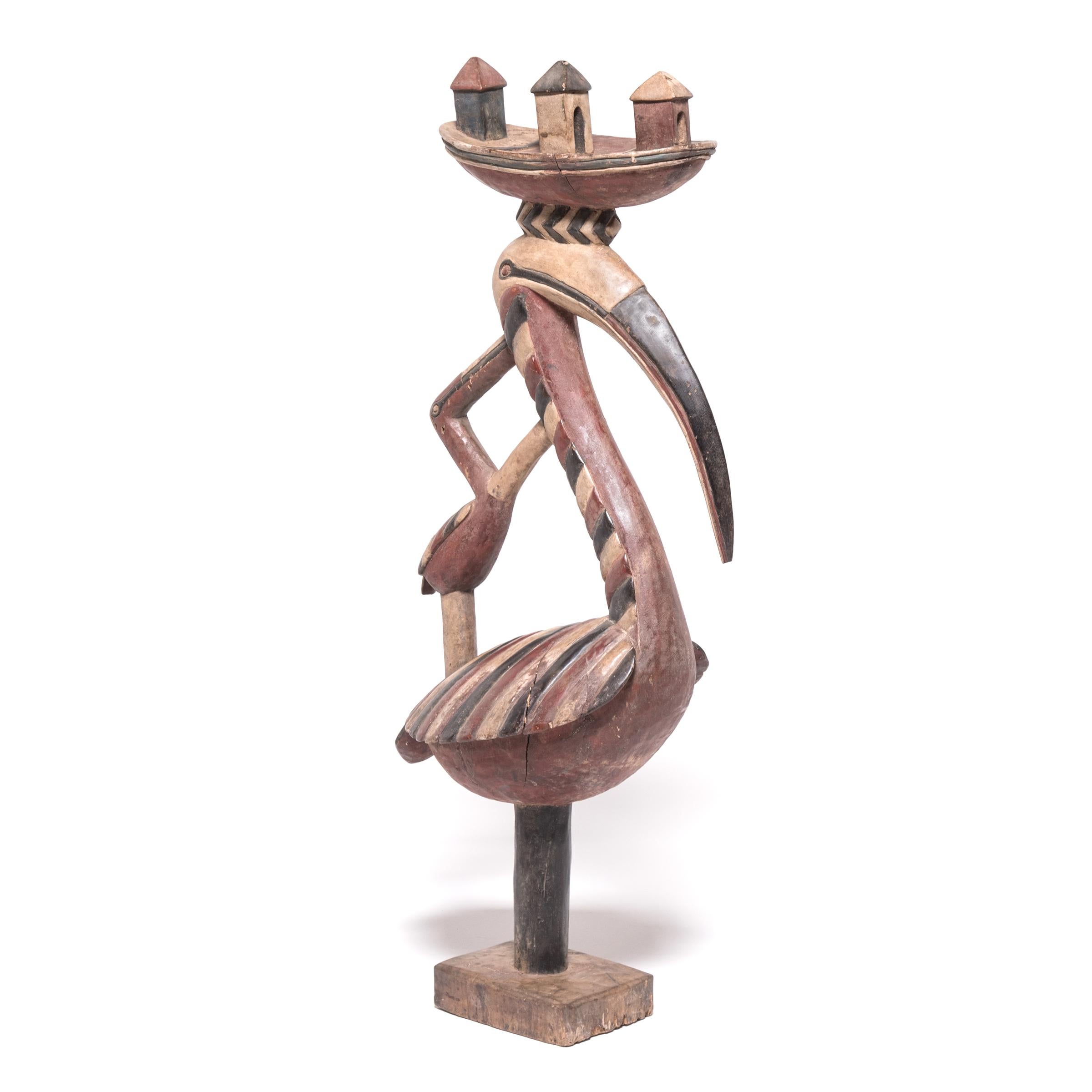 This graceful sculpture of a long-necked bird is a headdress known as 