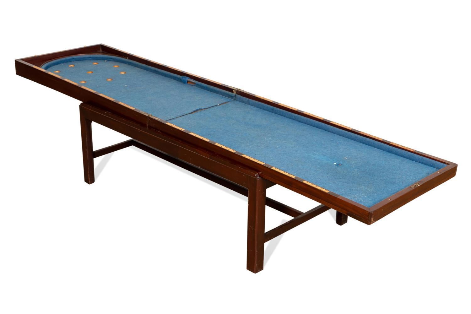 This unique item consists of a folded case that rests on a separate riser creating a graceful coffee table with a single end drawer. When the top case is unfolded it reveals a Bagatelle game board. The felt is in need of minor repairs.