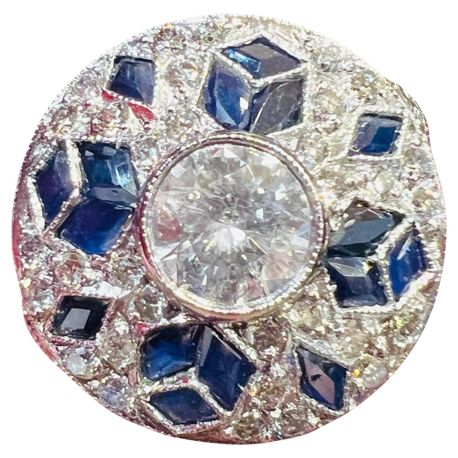 1930 period ring, made of platinum, set in its center with a 0.60 carat diamond surrounded by a paving of diamonds and calibrated sapphires

The basket is decorated with great refinement

Diamond paving: about 1 carat

Paving of calibrated
