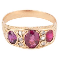 Bague jarretière ancienne en or, diamants et rubis