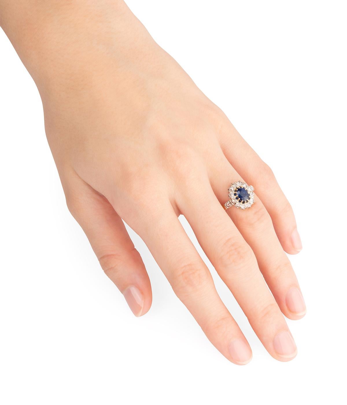 Bague marguerite ancienne en or jaune 18 carats (750 millièmes) de la fin du 19ème siècle, ornée d'un saphir taille ovale d'env. un carat entouré de diamants taille rose, diamants sur l'épaulement.

Poids total du bijou : 3,83 g.
Taille 51.
Longueur