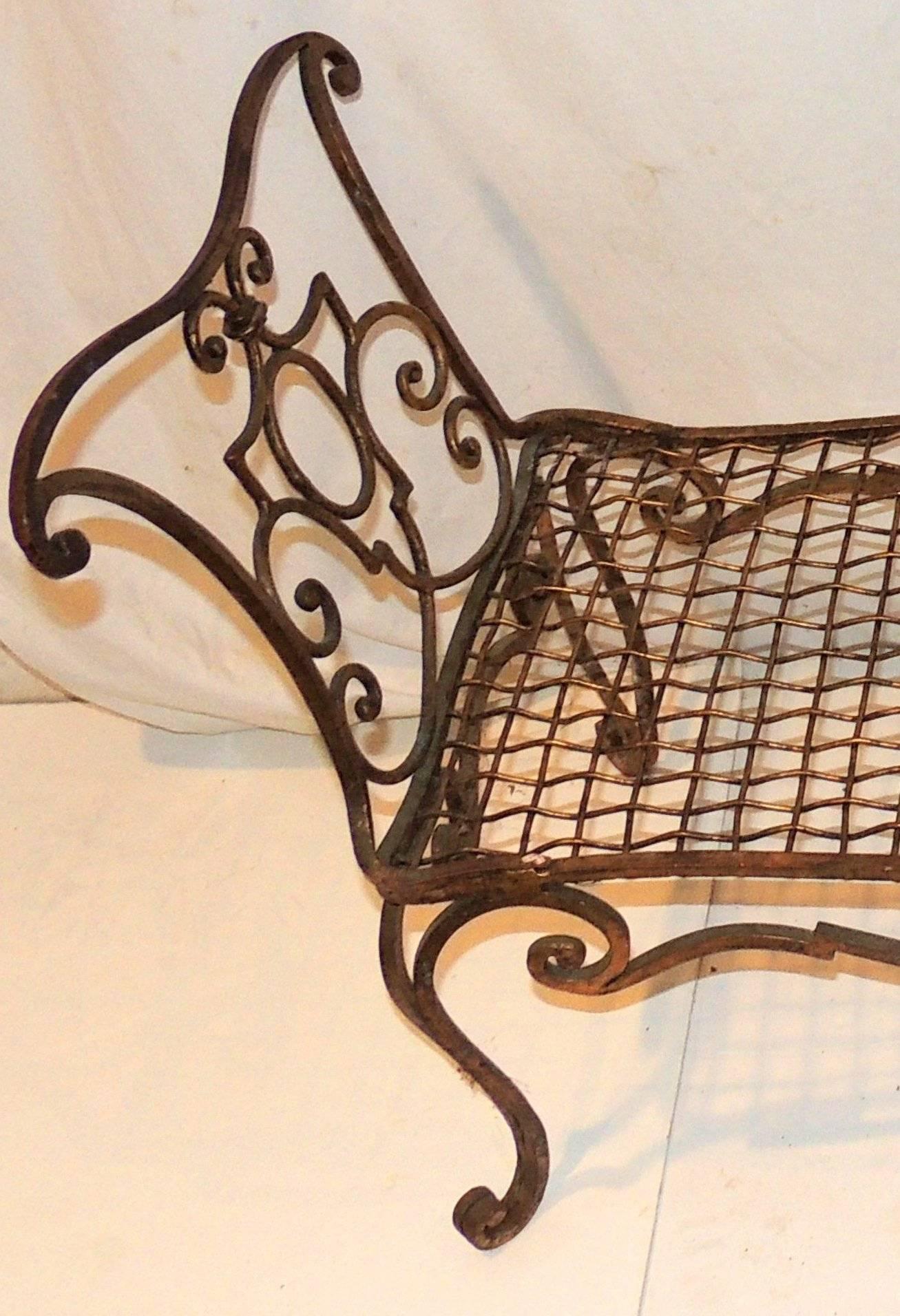 A wonderful French Jean Charles gilt wrought iron Baguès style bench with lattice seat and scrolled arms.
Measures: 13