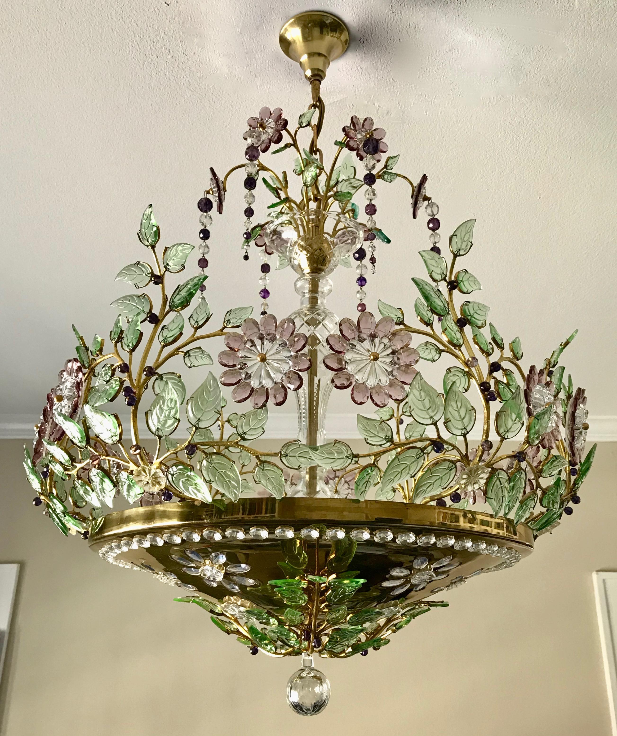 Chandelier composed of scrolling branches and glass leaves highlighted with amethyst and clear glass flowers. 6 - A or Edison base light bulbs concealed within the brass bowl illuminate the glass elements above as well as the brass bowl. Newly wired