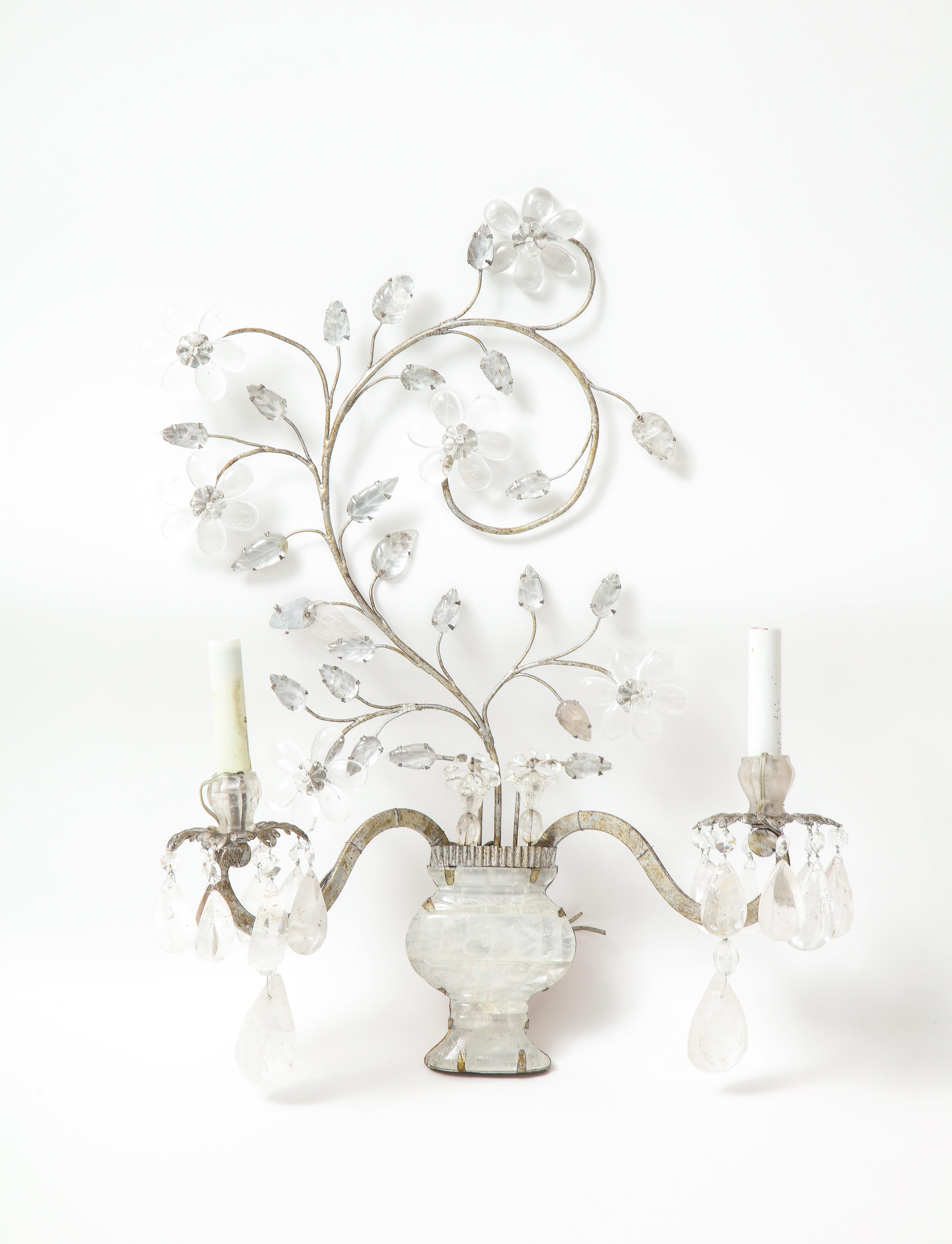 A wonderful pair of two arm Bagues style rock crystal sconces with urn and Foliage design.