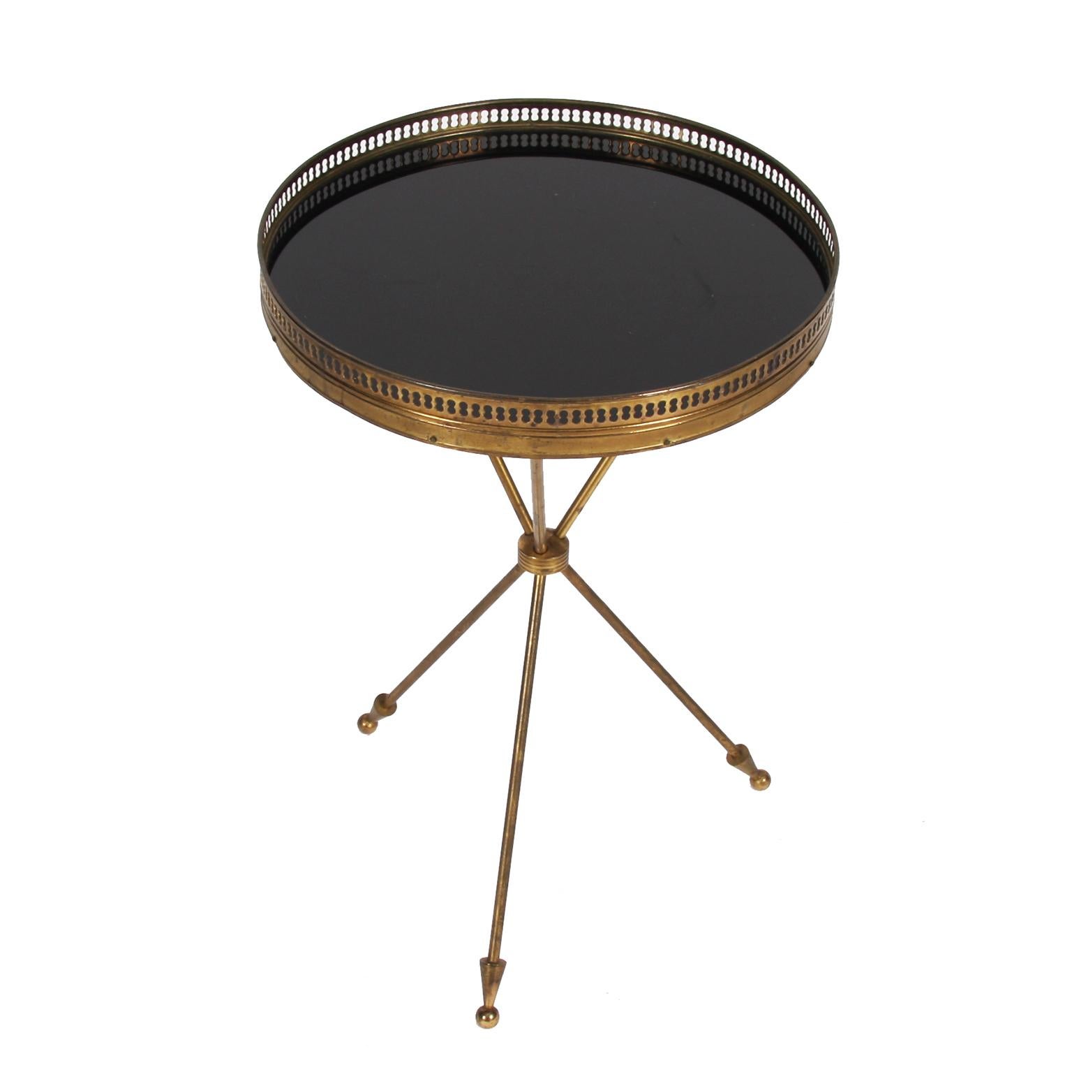 French, 1960s

A brass and black glass side table in the style of Bagues. 

With tripod base and galleried top.