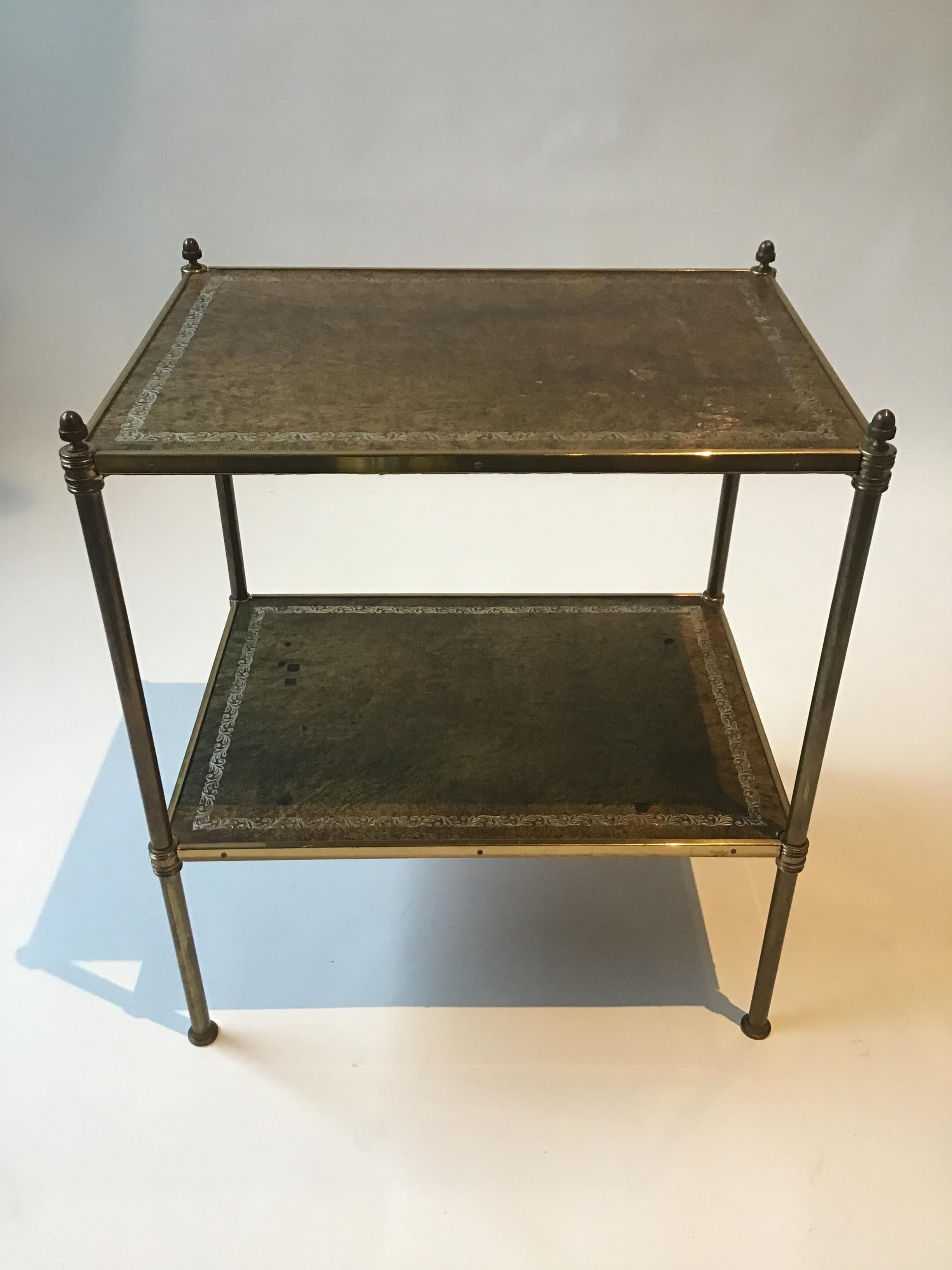 1950s Baguès style two tier leather and brass side table.
This table can be shipped through UPS.