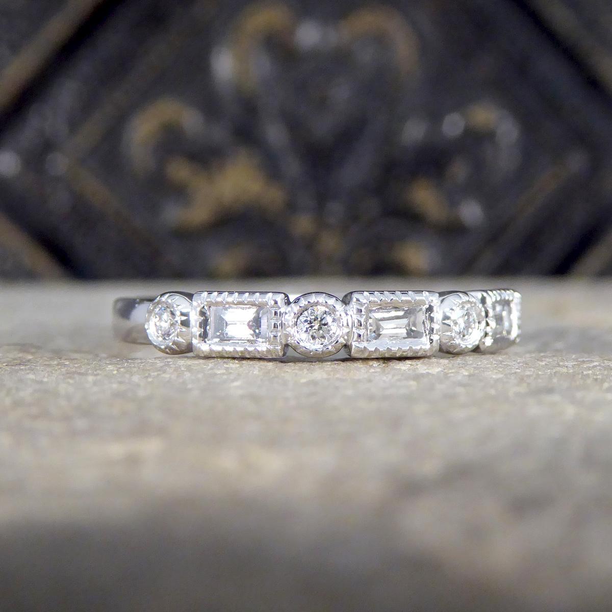 Experience timeless elegance with this Baguette and Brilliant Cut Diamond half eternity band, exquisitely crafted in sleek platinum. This band beautifully combines the sharp, clean lines of baguette-cut diamonds with the sparkling brilliance of