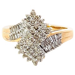 Diamant-Drehring mit Baguette- und Brillantschliff aus 14K Gelbgold
