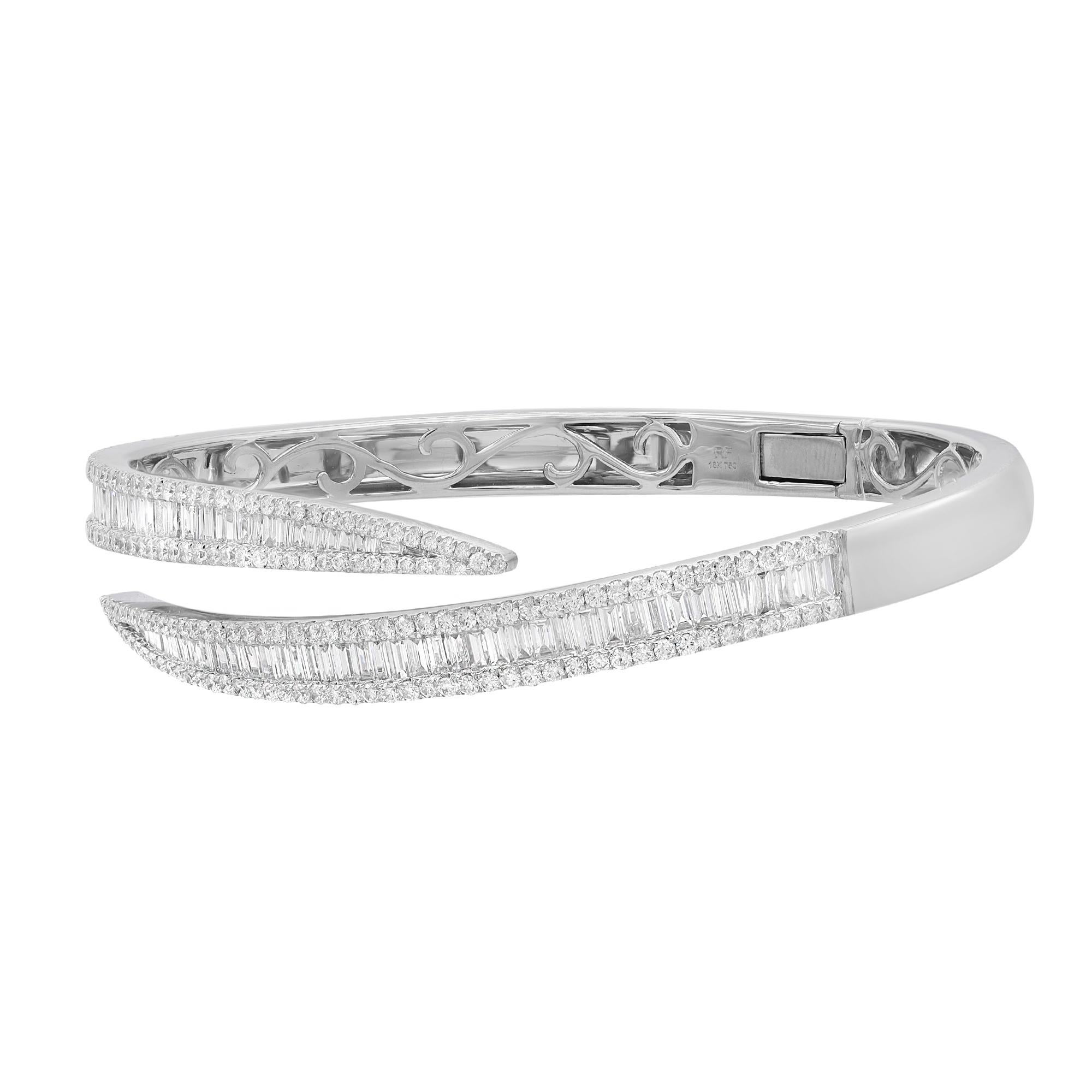 A classic look with easy elegance, this diamond bangle bracelet exudes sophistication. This stunning bracelet is crafted in 18k white gold and features channel set baguette cut and round cut diamonds with a total diamond weight of 3.95 carats.