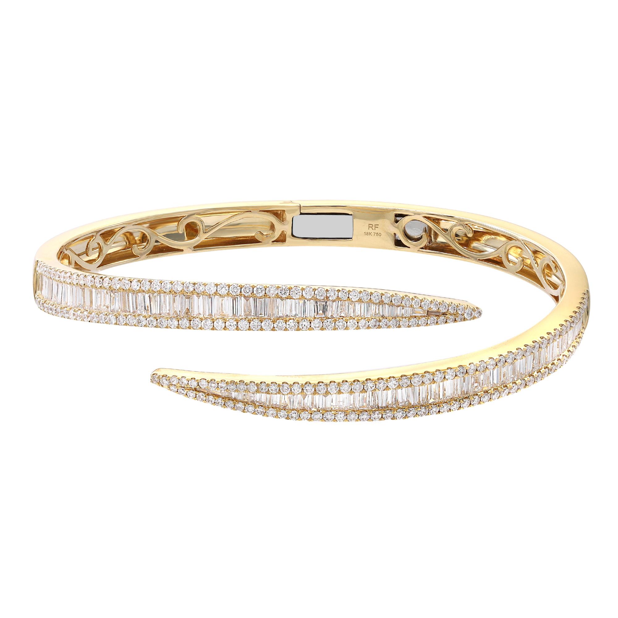 A classic look with easy elegance, this diamond bangle bracelet exudes sophistication. This stunning bracelet is crafted in 18k yellow gold and features channel set baguette cut and round cut diamonds with a total diamond weight of 3.76 carats.