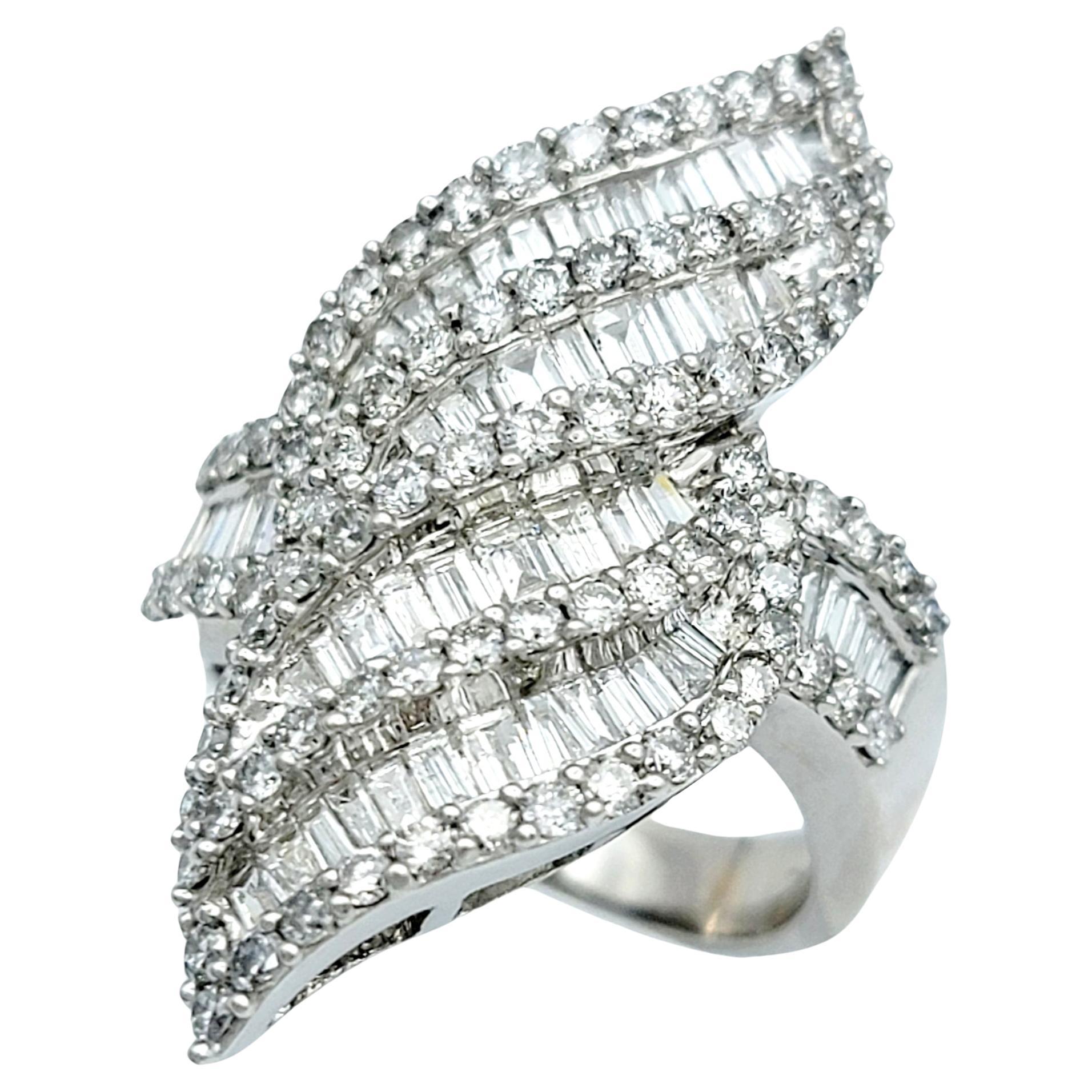 Ring size: 7.5

This lustrous, sparkling cocktail ring is a captivating embodiment of modern artistry and timeless luxury. Crafted in shimmering 14 karat white gold, its design is a marvel, resembling fiery flames that dance with movement. This