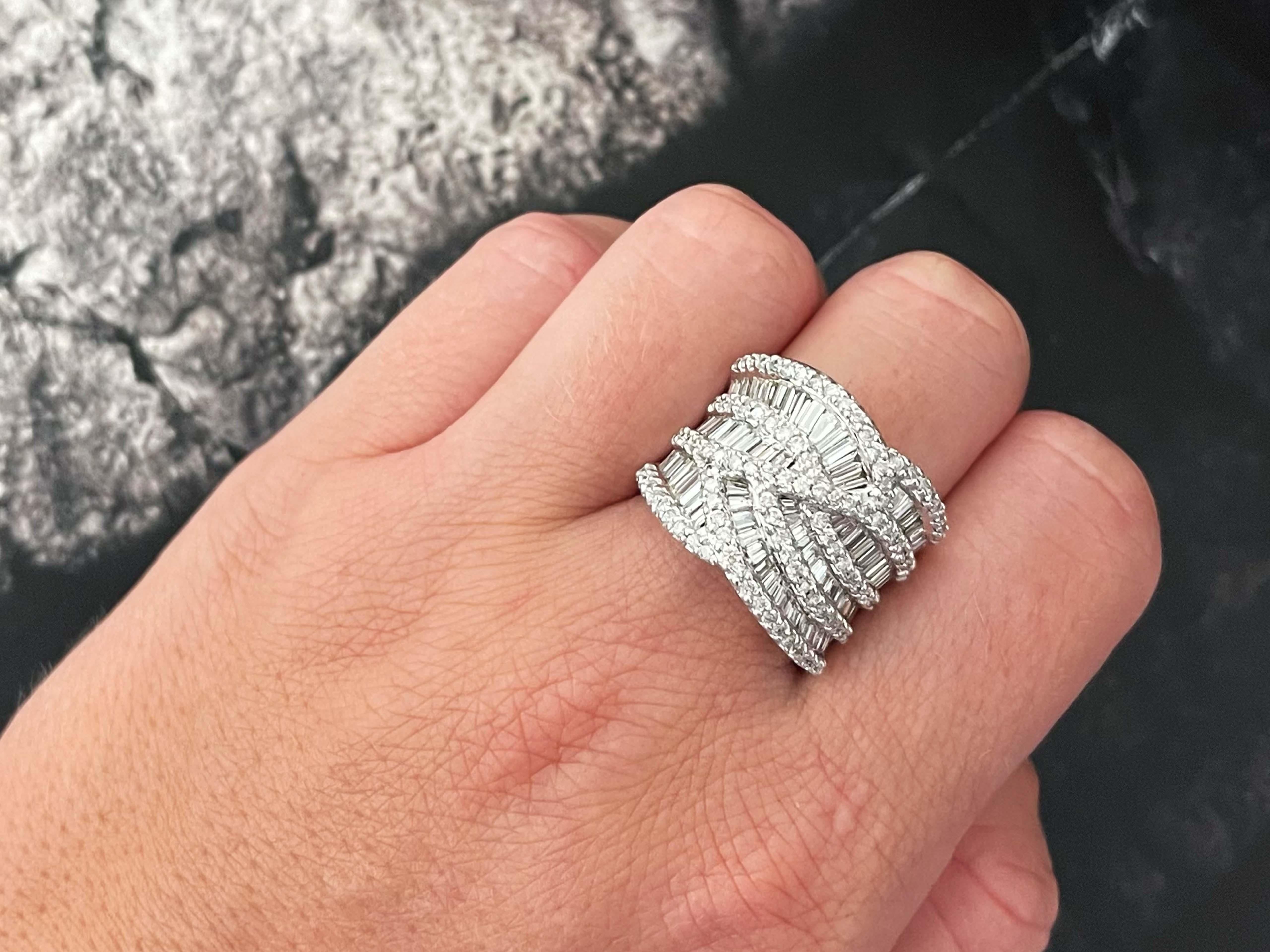 Item Specifications:

Metal: 18k White Gold

Diamond Count: 102 round brilliant diamonds & 92 baguette = 194 diamonds
​
Total Diamond Carat Weight: ~4 carats

Diamond Color: G

Diamond Clarity: VS

Ring Width: ~19 mm

Ring Size: 7 (resizable)

Total