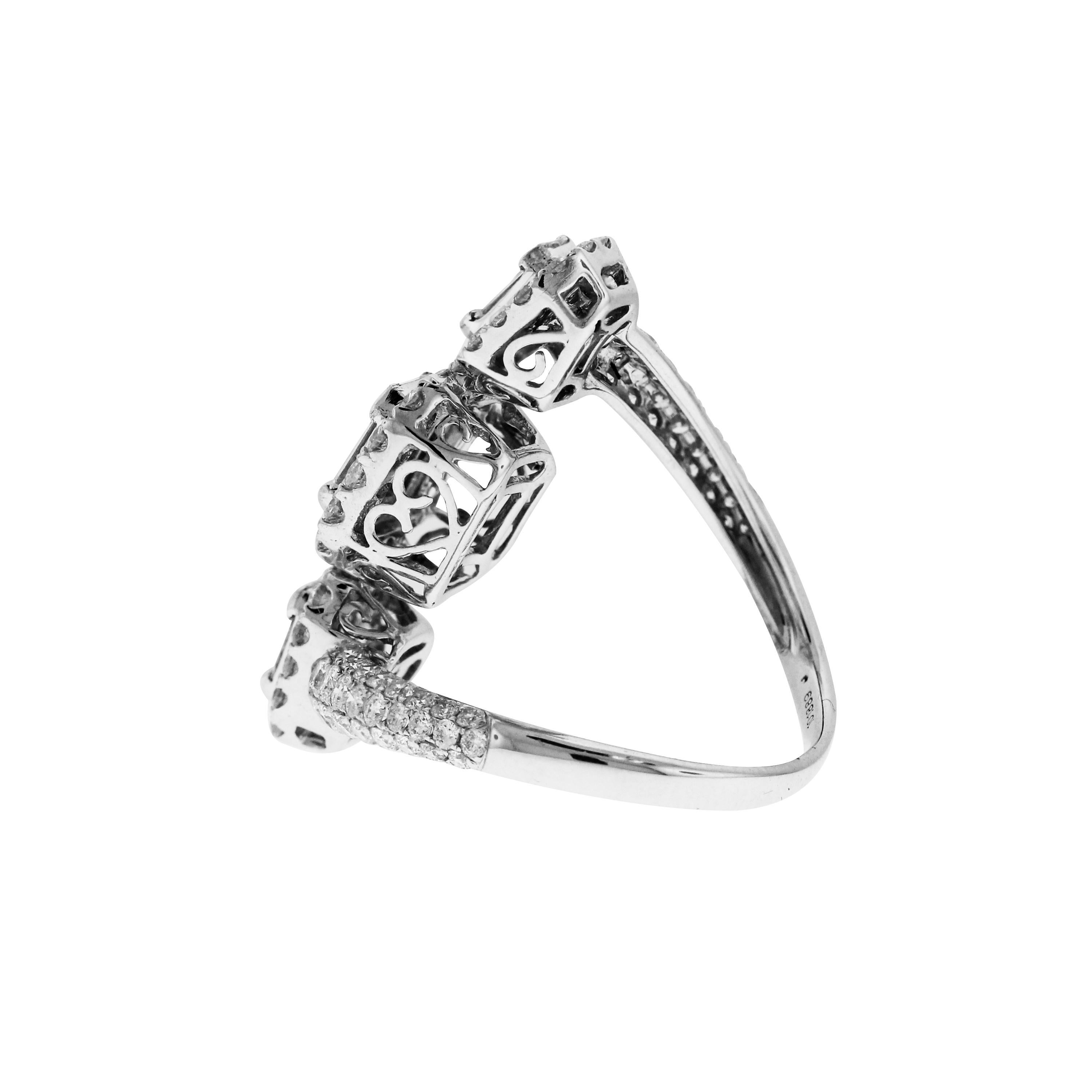 18K White Gold and Baguette Diamond Bypass Ring

Apprx. 3.50 carat G color, VS clarity diamonds. Baguette and Round cuts

Ring face is 1.1 inch by 0.35 inch

Size 8.25. Sizable.
