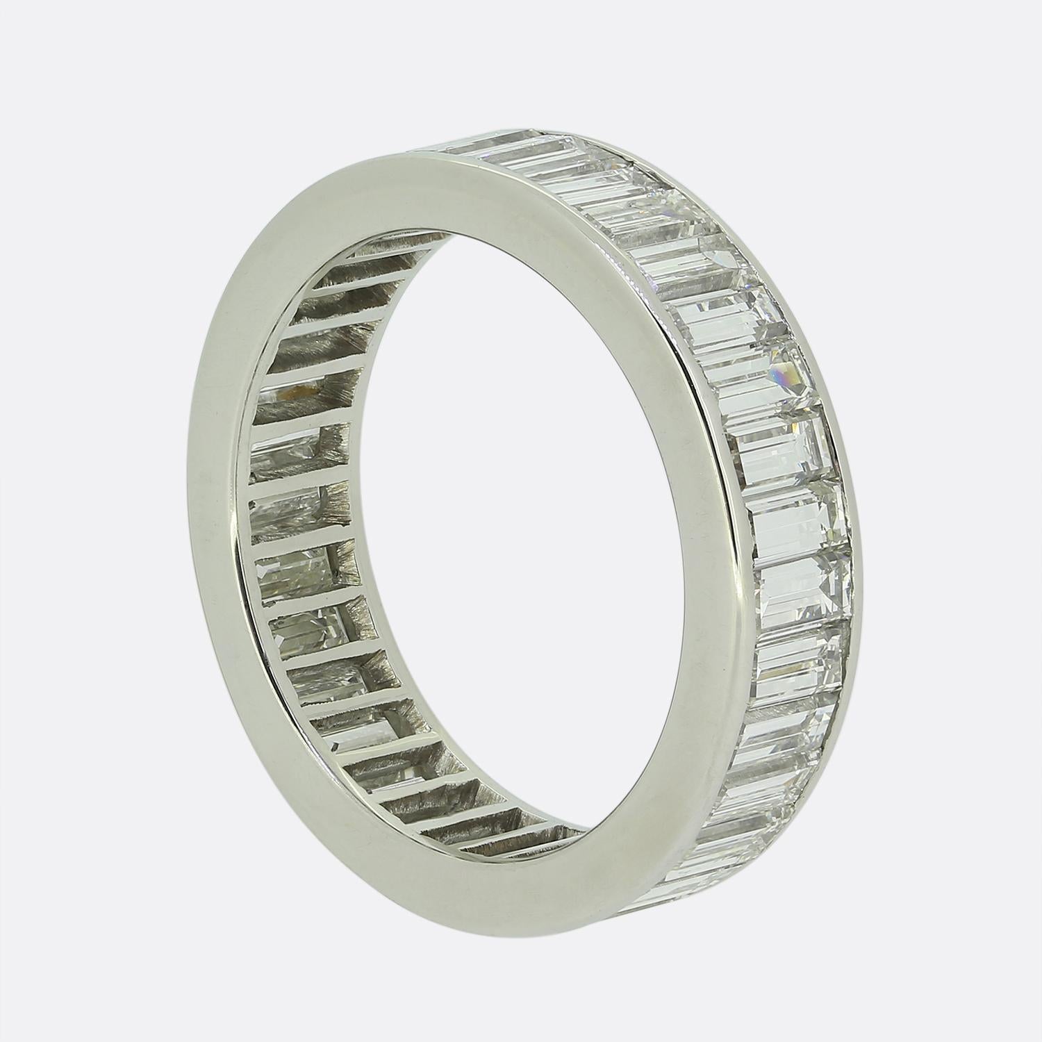 Here we have a fabulous diamond eternity ring. This platinum piece showcases a continuous row of bright white straight baguette-cut diamonds, meticulously channel set to maximise their elegance and shine. The band is smooth and polished, offering a