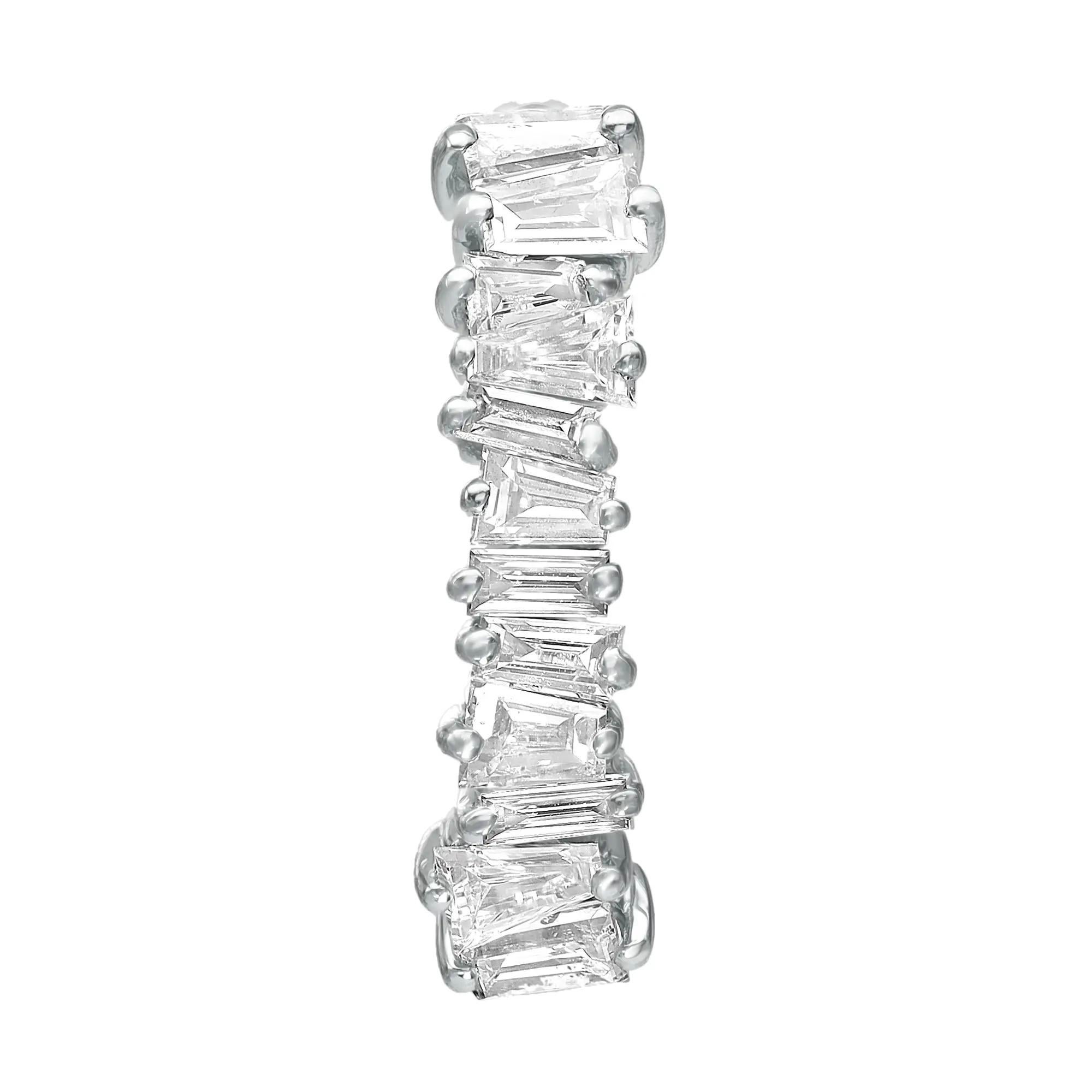Sparkle all way with these beautiful diamond huggie earrings. Crafted in fine 18K white gold. These earrings feature prong set tapered baguette diamonds encrusted halfway through the earring. Total diamond weight: 0.58 carat. Diamond color G-H and