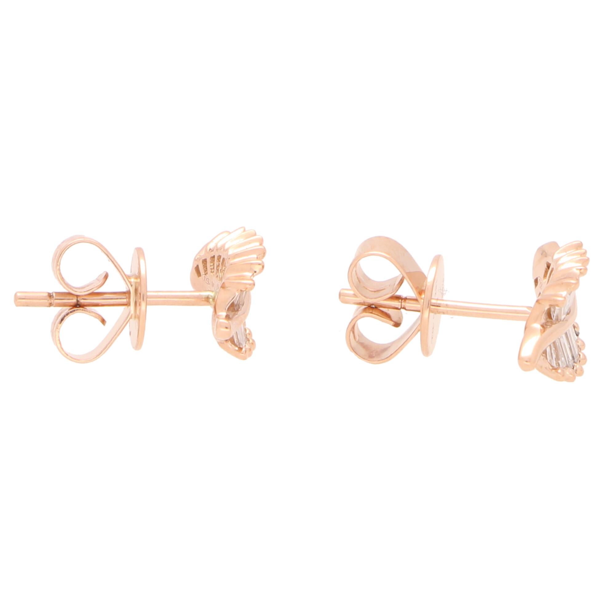  A lovely little pair of diamond leaf stud earrings set in 18k rose gold.

These beautiful little studs are each individually set with 13 tapered baguette cut diamonds claw set to depict the grooves of a natural leaf. Due to the design these studs