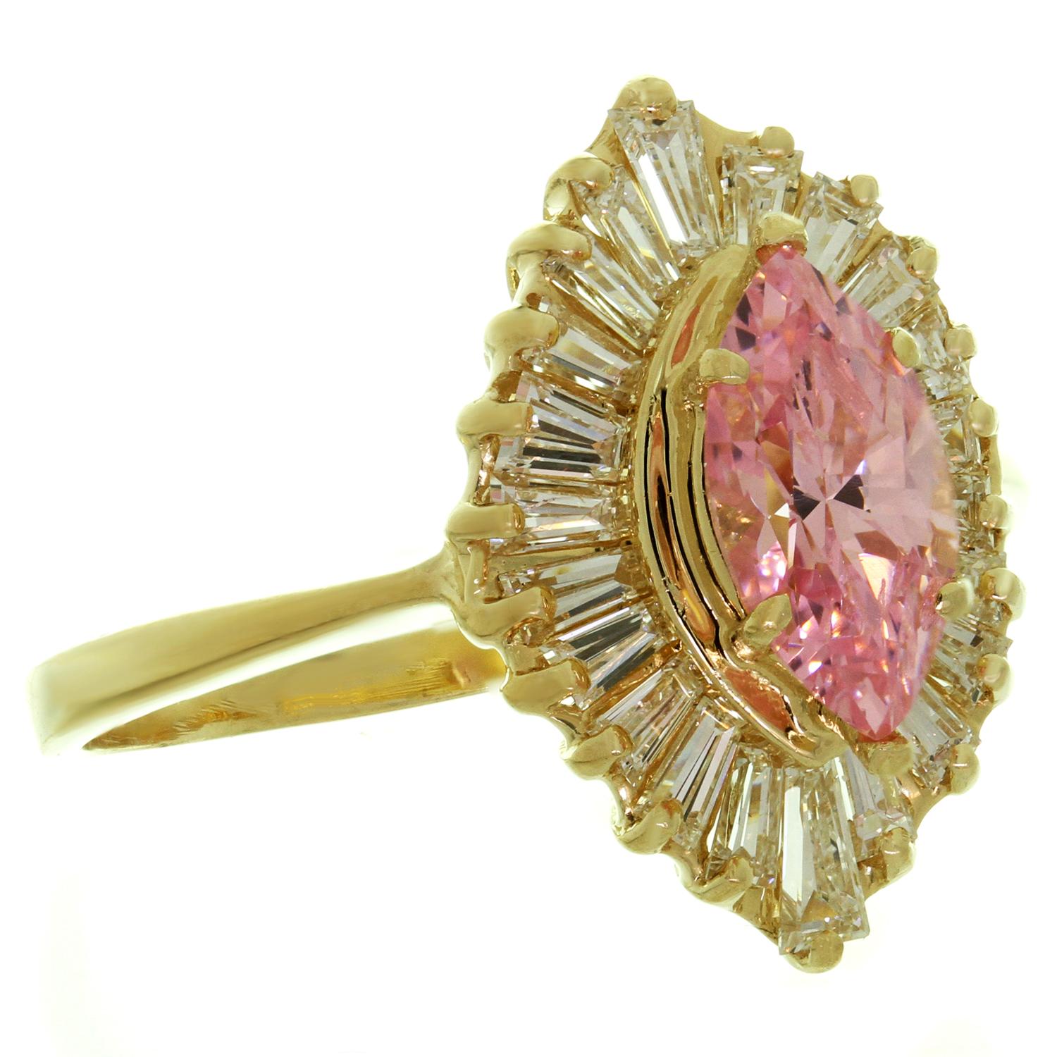 This elegant ballerina ring is crafted in 14k yellow gold and set with a pink zircon and round G-H VS1-VS2 baguette-cut diamonds of an estimated 1.00 carats. Made in United States circa 1980s. Measurements: 0.47