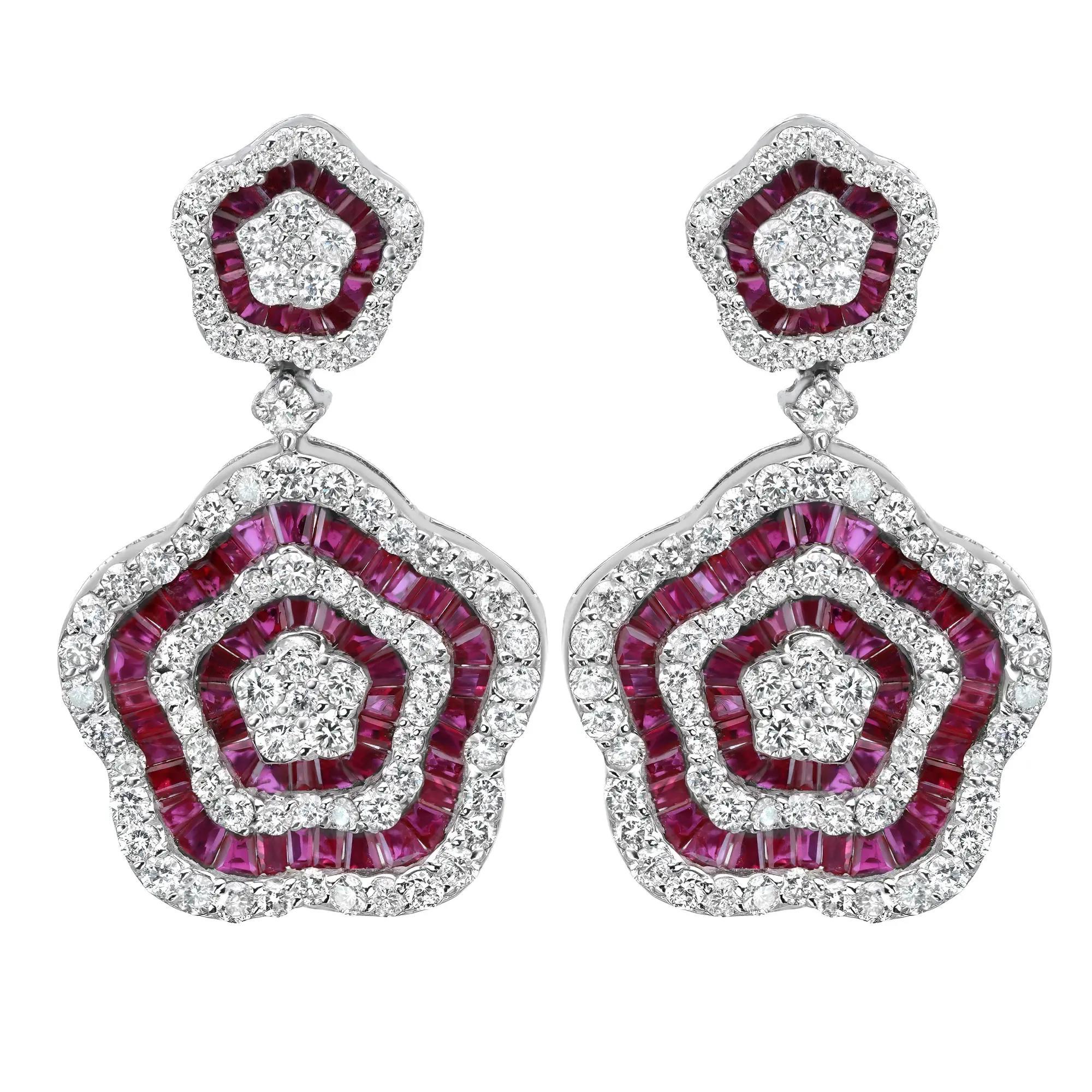 Experience the full bloom of Rubies and Diamonds with these stunning flower drop earrings, expertly crafted in 14K white gold. They showcase channel set baguette cut rubies and pave set round brilliant cut diamonds encrusted in both small and large