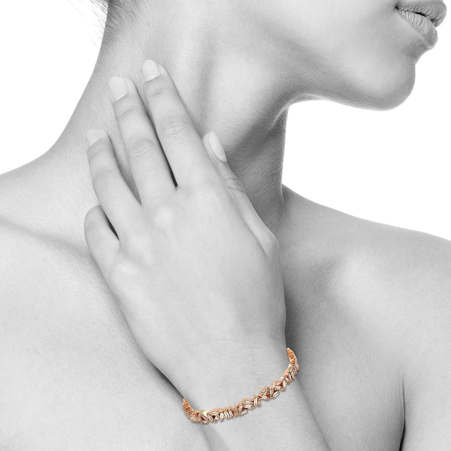 A stunning bracelet handmade in 18K rose gold. It is set in 2.79 carats of baguette diamonds. Wear it alone or stack it with your favorite pieces. Bangle circumference is 6-in. Bangle is 3/16-in. wide. Chain Opening measures 1/2-in. across

FOLLOW 