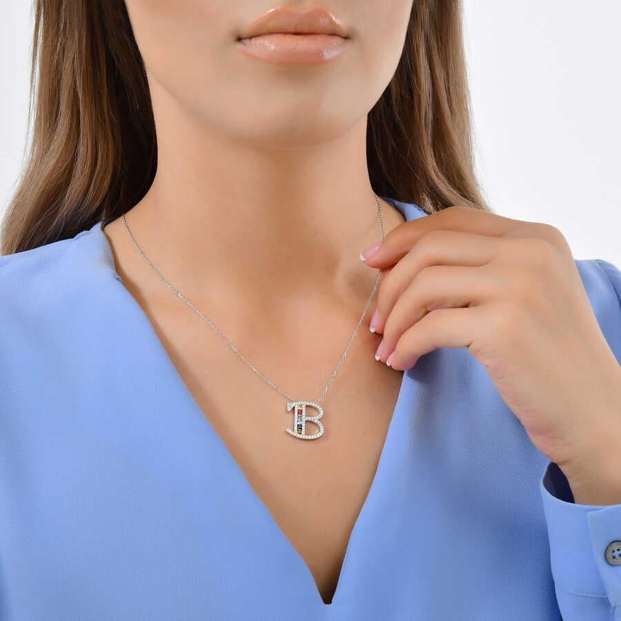 This Beautiful Baguette Diamond Letter Pendant Is Entirely Handcrafted In 14 Karat White Gold. 
The Letter B Pendant Is Brilliant Round Diamonds and Princess Cut Sapphires Weighing .96 Carats.

Sapphire Diamond: 0,56ct ( 6 Pieces Princess Cut )