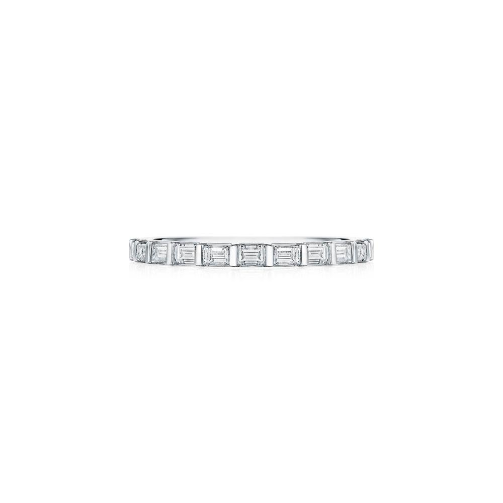 • Crafted in 14KT White Gold, this band is made with 11 baguette cut diamonds. The diamonds are set half way down the band and are secured in a bar setting. The band has a combining total weight of approximately 0.39 carats. 
Worn beautifully on its
