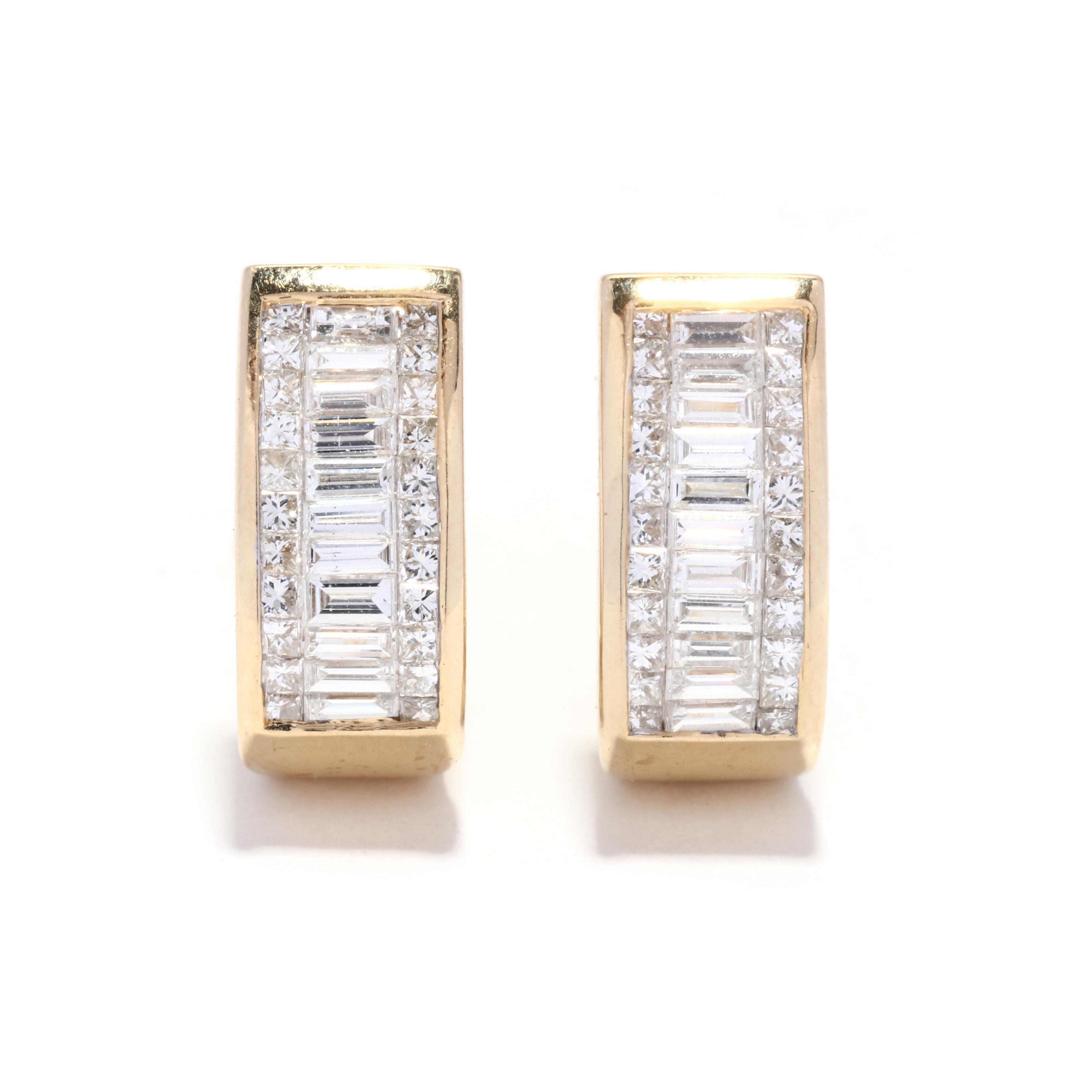 A pair of vintage 14 karat yellow gold baguette diamond hoop earrings. These wide hoops feature a J hoop design with horizontal illusion set baguette cut diamonds weighing approximately 1 total carat with a row of princess cut diamonds on either