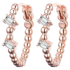 Orecchini a cerchio con diamanti baguette in oro rosa 18 carati