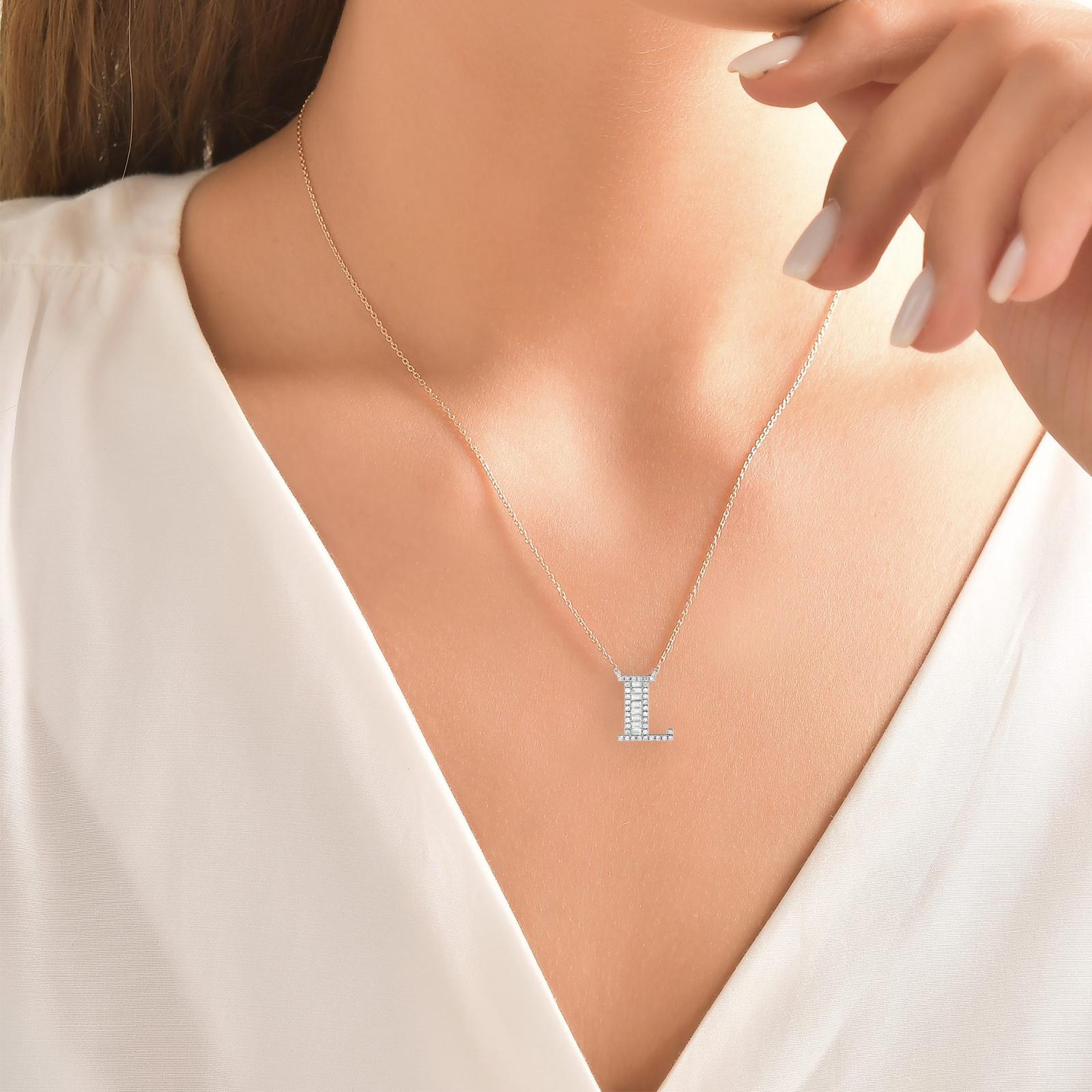 This Beautiful Baguette Diamond Letter Pendant Is Entirely Handcrafted In 14 Karat White Gold. 
The Letter L Pendant Is Garlanded With Channel-Set Baguette-Cut Diamonds And Prong Set Brilliant Round Diamonds Weighing 0.40 Carats. All Of The Stones