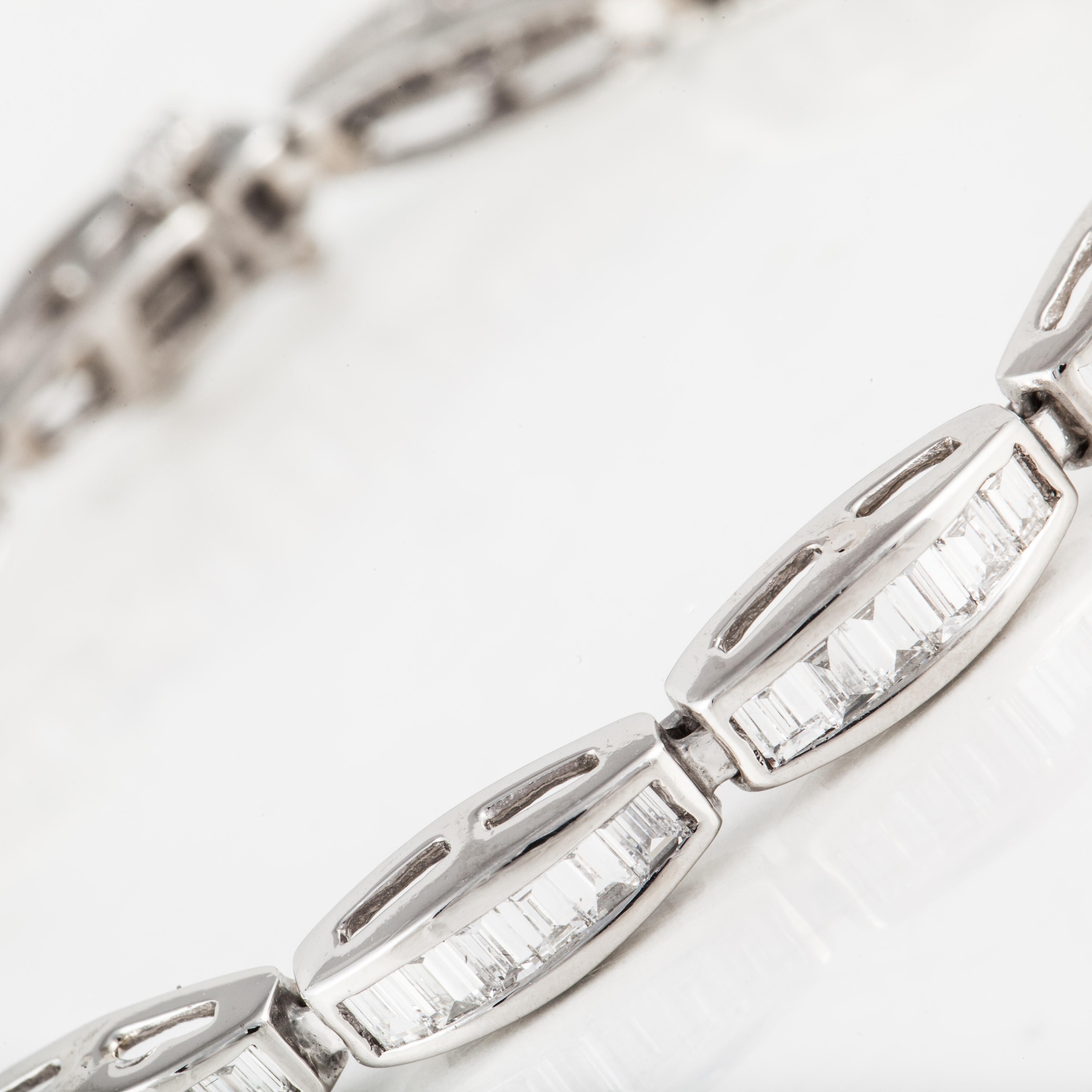 This classic line bracelet is platinum and baguette diamonds.  There are eighty-four (84) diamonds  totaling 6.8 carats; G-H color and VS1-VS2 clarity.  It is marked 