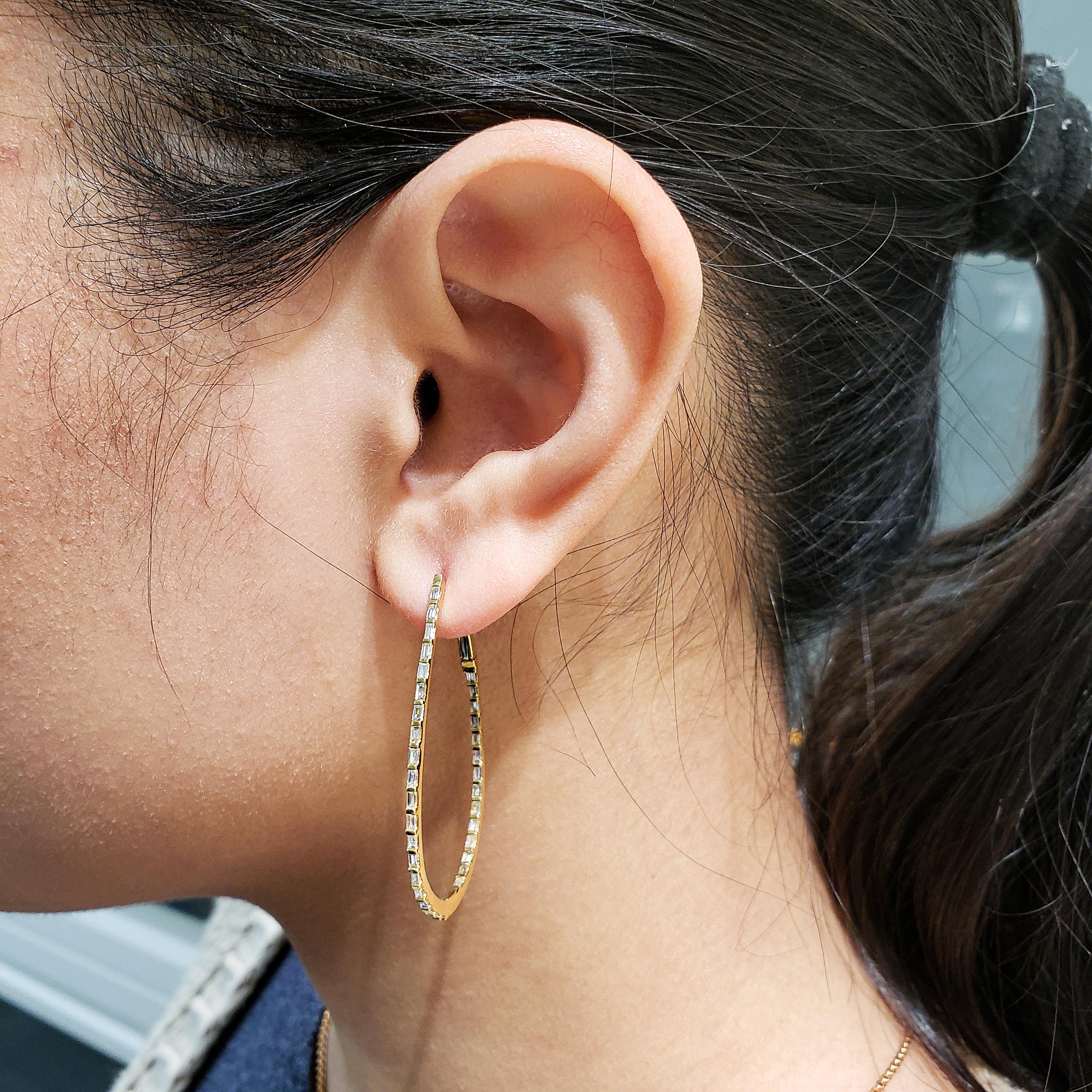 A unique and stylish pair of hoop earrings showcasing a row of baguette diamonds, Bar set in a tear drop hoop design. Diamonds weigh 0.98 carats total. Made in 18 karat yellow gold.

Style available in different price ranges. Prices are based on