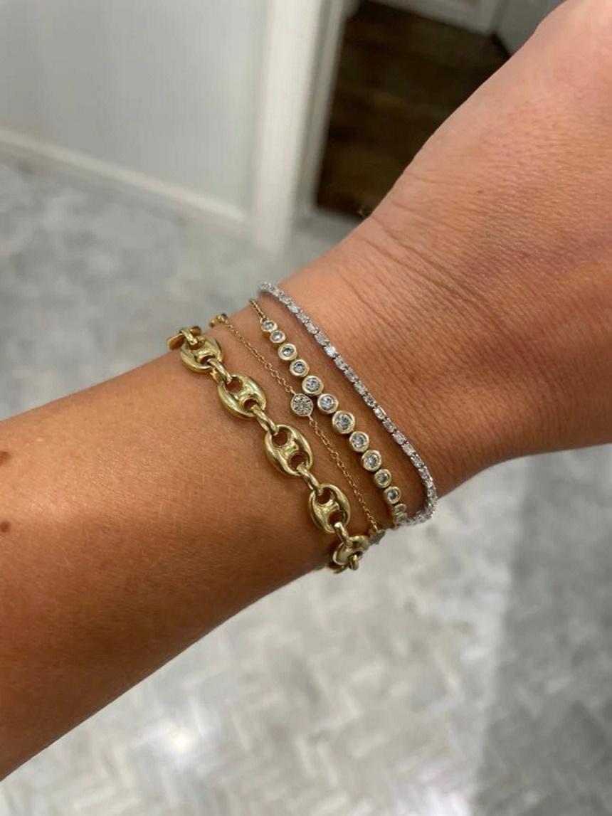 Meet our Baguette Diamond Tennis Bracelet 14K! This gorgeous thin tennis bracelets features baguette cut green diamonds set in 14k gold. It's the perfect everyday accessory and is also a great choice for April birthdays. The emerald cut is a modern