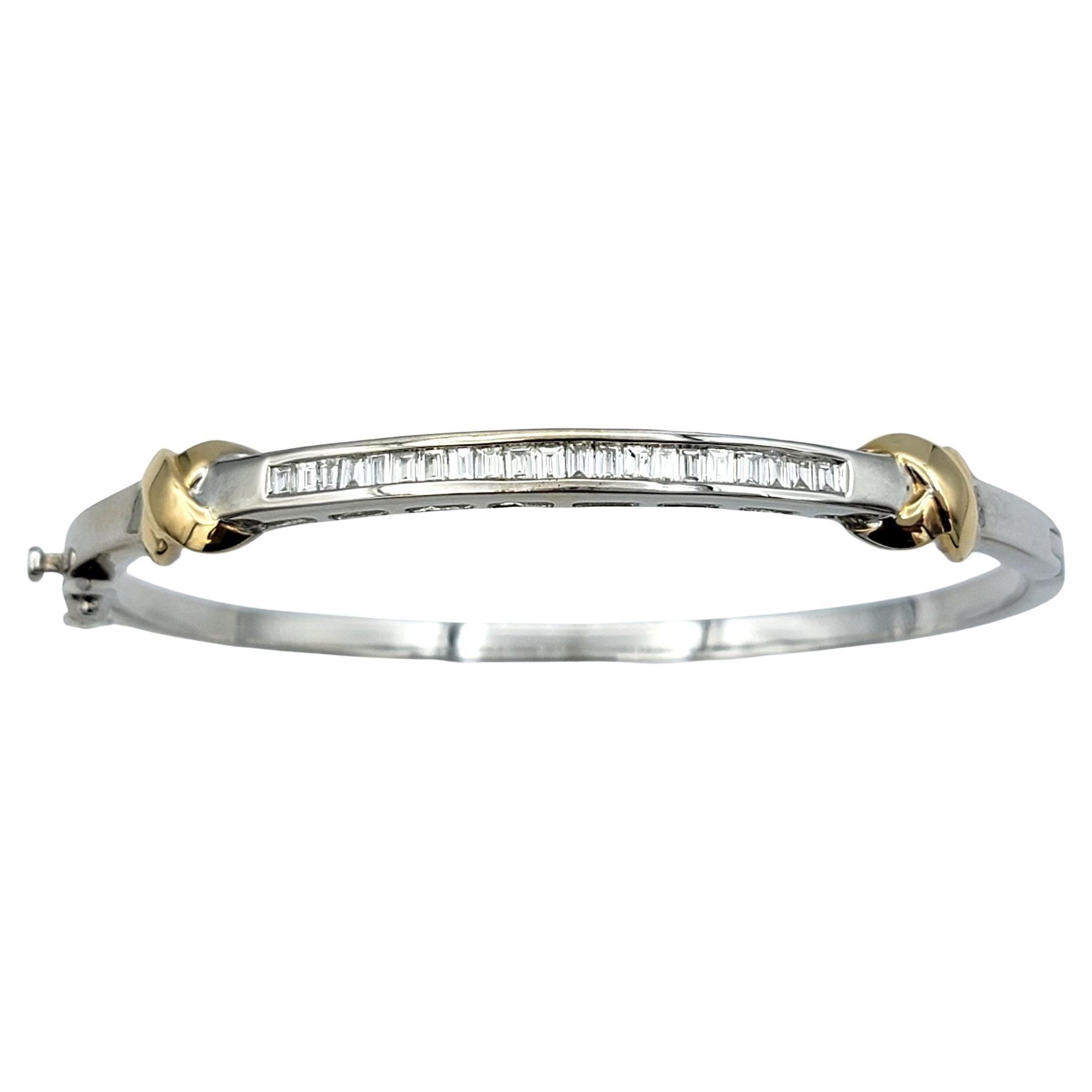 This exquisite hinged bracelet marries the classic elegance of baguette diamonds with a contemporary twist of contrasting white and yellow gold accents. Crafted with meticulous attention to detail, the bracelet features a series of baguette diamonds