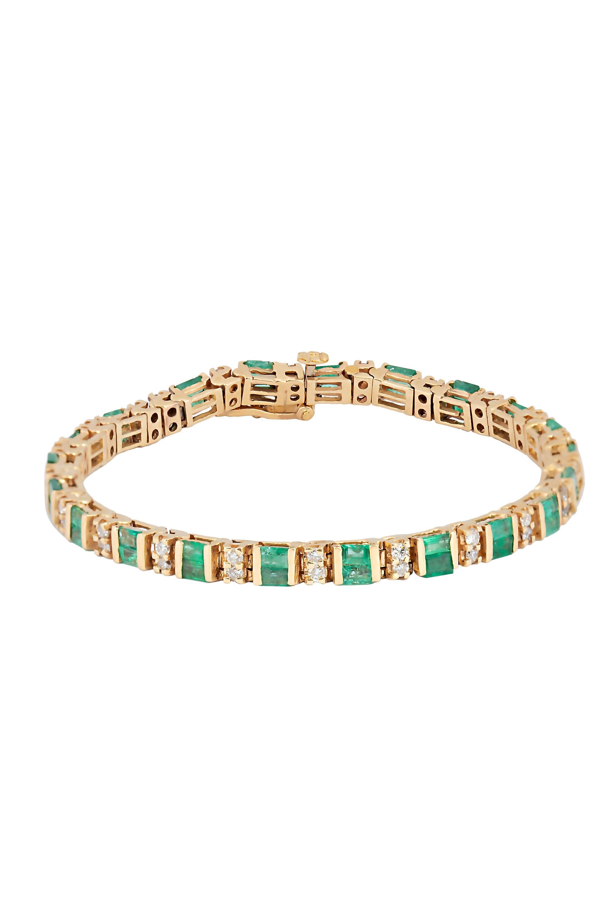 A classic tailored tennis bracelet crafted in 18 karat yellow gold and composed of rows of double stacked emerald baguettes interspersed by stations of double stacked round brilliant diamonds. Set with a total of 4.20 carats in emeralds and 1.32