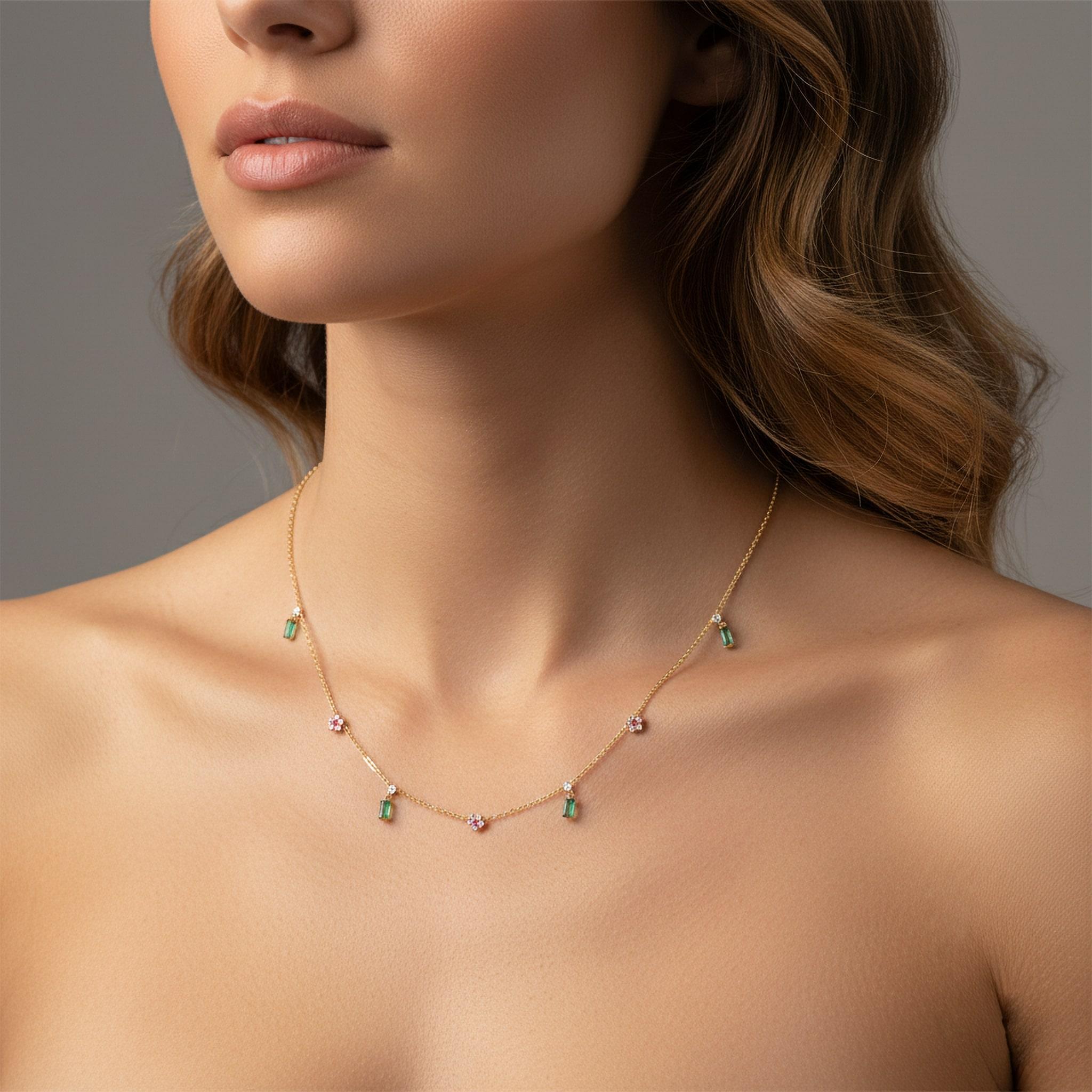 Capture the charm of a bygone era with the Baguette Emerald Round 14K Yellow Gold Ruby Charms Necklace, a timeless creation in 14K yellow gold. Featuring natural diamonds intricately set in vintage-inspired stations, this necklace exudes elegance