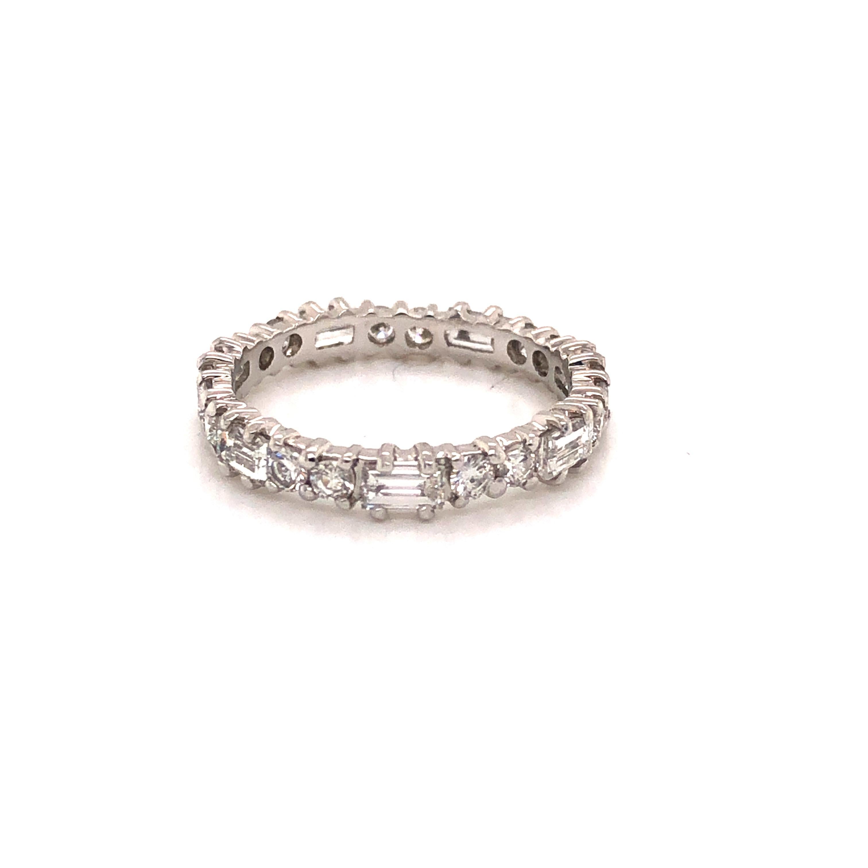 Beautiful ring crafted 18k white gold. The ring is highlighted with natural Baguette and Round cut diamonds. 
This wedding band features alternating diamonds as two rounds are set against east west set baguette cut diamonds, approximately 1.68