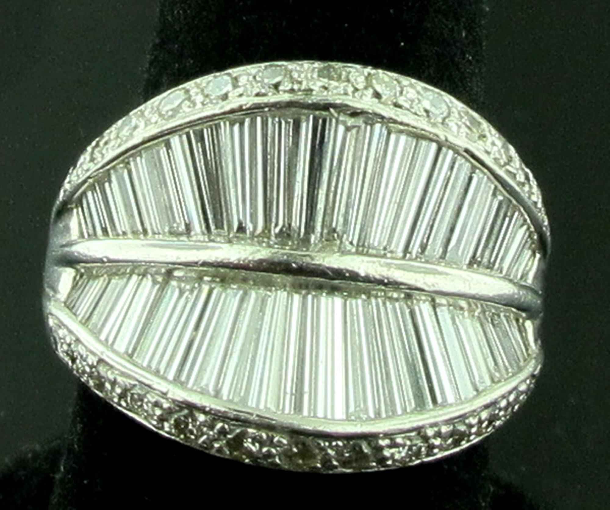 Set in Platinum are 56 tapered baguette cut diamonds along with 26 round brilliant cut diamonds on the rim for a total diamond weight of 3.40 carats.  G-H Color, VS - SI Clarity.  Ring size is 7.