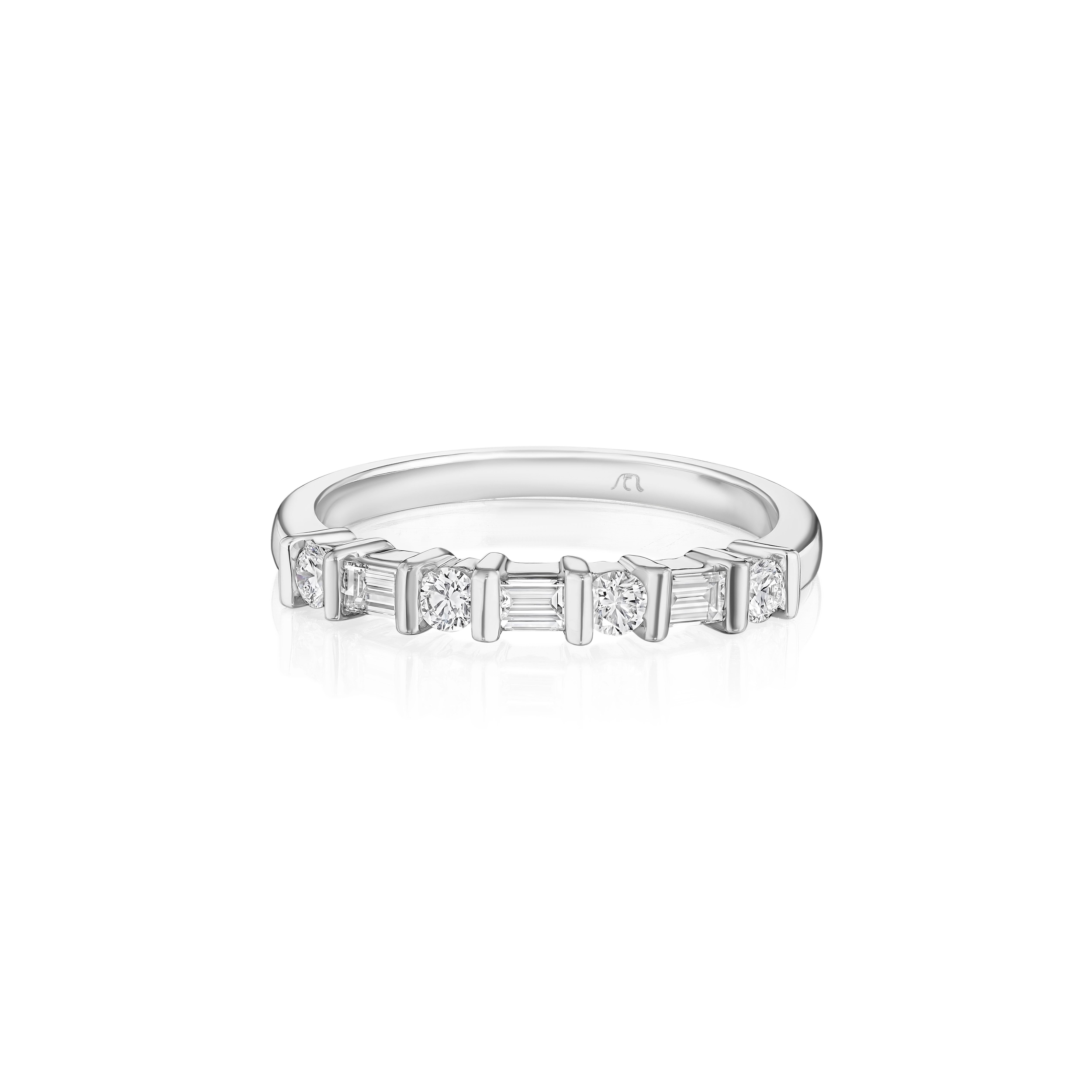 •	Crafted in 18KT Gold, this band is made with alternating round and baguette cut diamonds. The stones are secured in a bar setting and has a combining total weight of approximately 0.45 carats. 
Worn beautifully on its own or stacked. A beautiful