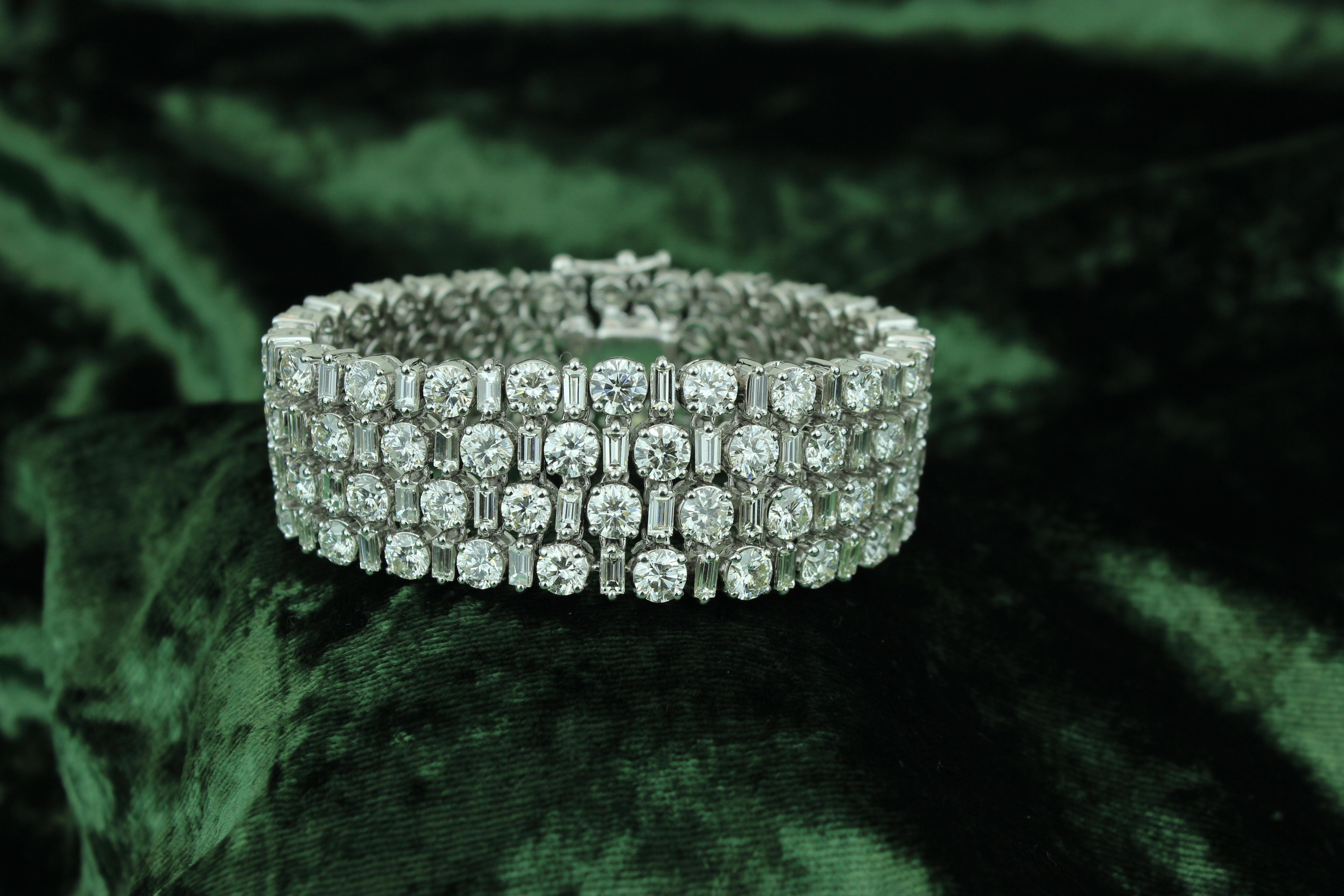 This bracelet features a broad design that adds a sense of opulence and grandeur to your persona. Crafted from 18k solid gold, the alternating arrangement of baguette and round diamonds creates a captivating visual pattern. Baguette diamonds, with