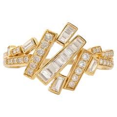 Anello incrociato con diamanti tondi e baguette