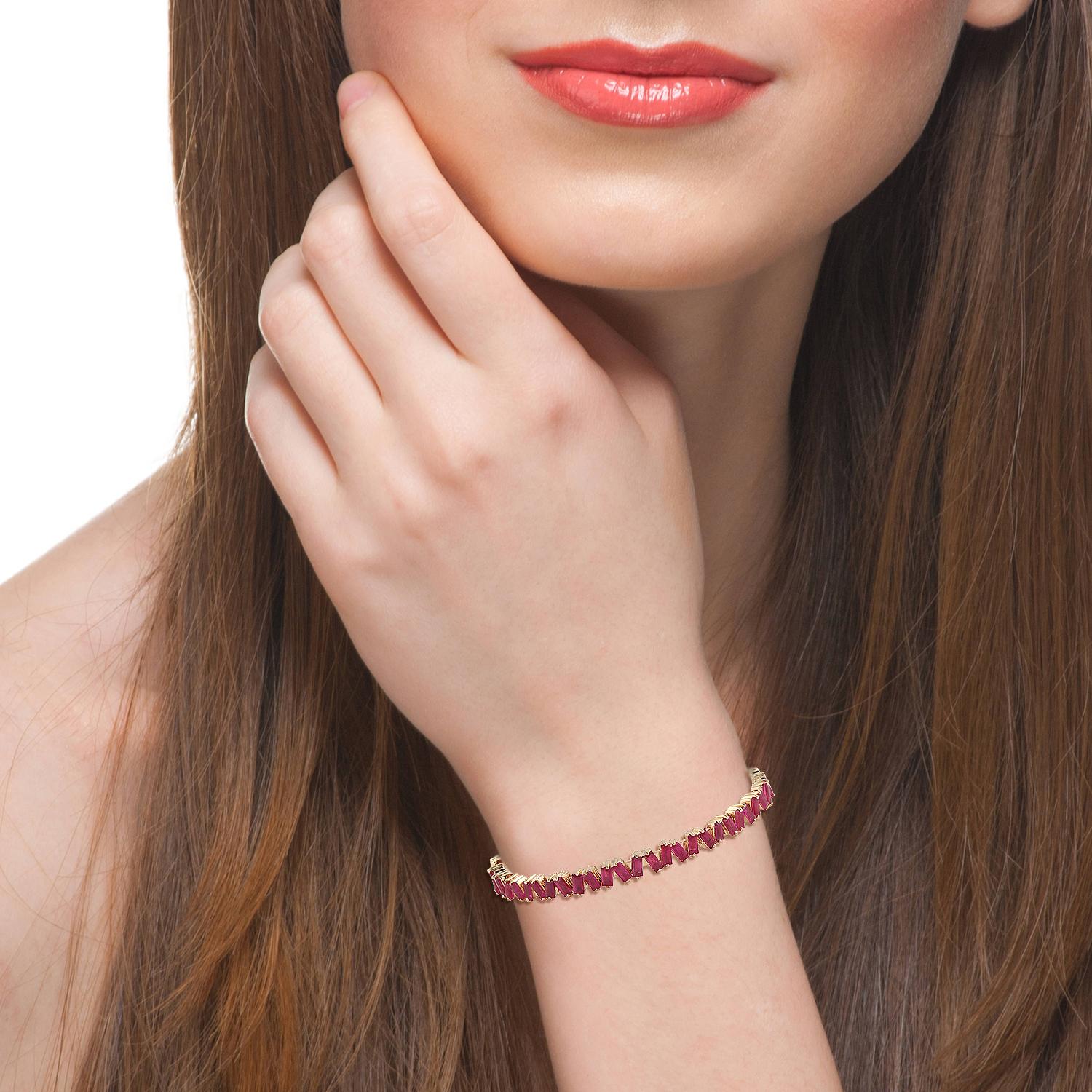 A stunning bracelet handmade in 18K gold. It is set in 4.27 carats of baguette ruby. Wear it alone or stack it with your favorite pieces. Bangle circumference is 6-in. Bangle is 3/16-in. wide. Opening measures 1/2-in. across

FOLLOW  MEGHNA JEWELS