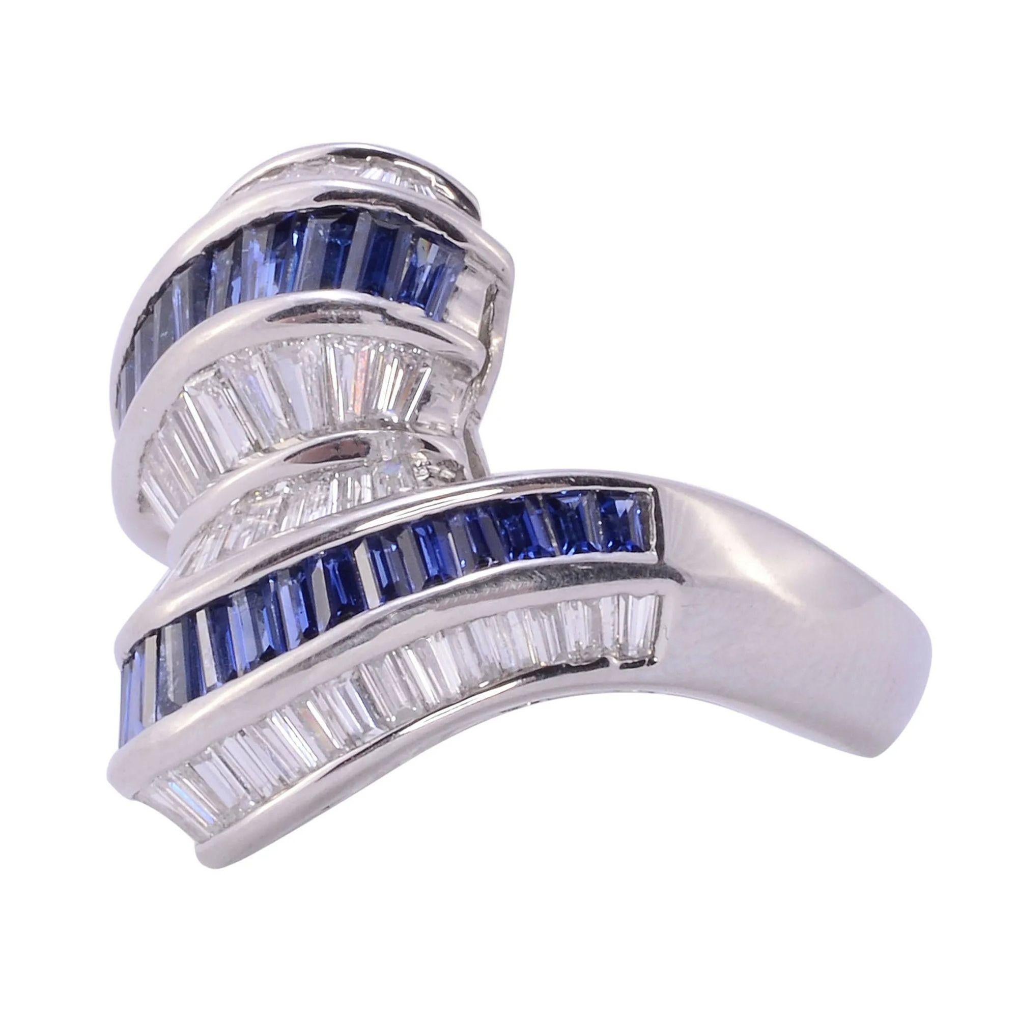Estate baguette sapphire & diamond platinum ring. This platinum ring features 57 tapered diamonds at 1.29 carat total weight having SI clarity and G-H color. There are also 32 baguette sapphires at 1.34 carat total weight. This sapphire & diamond