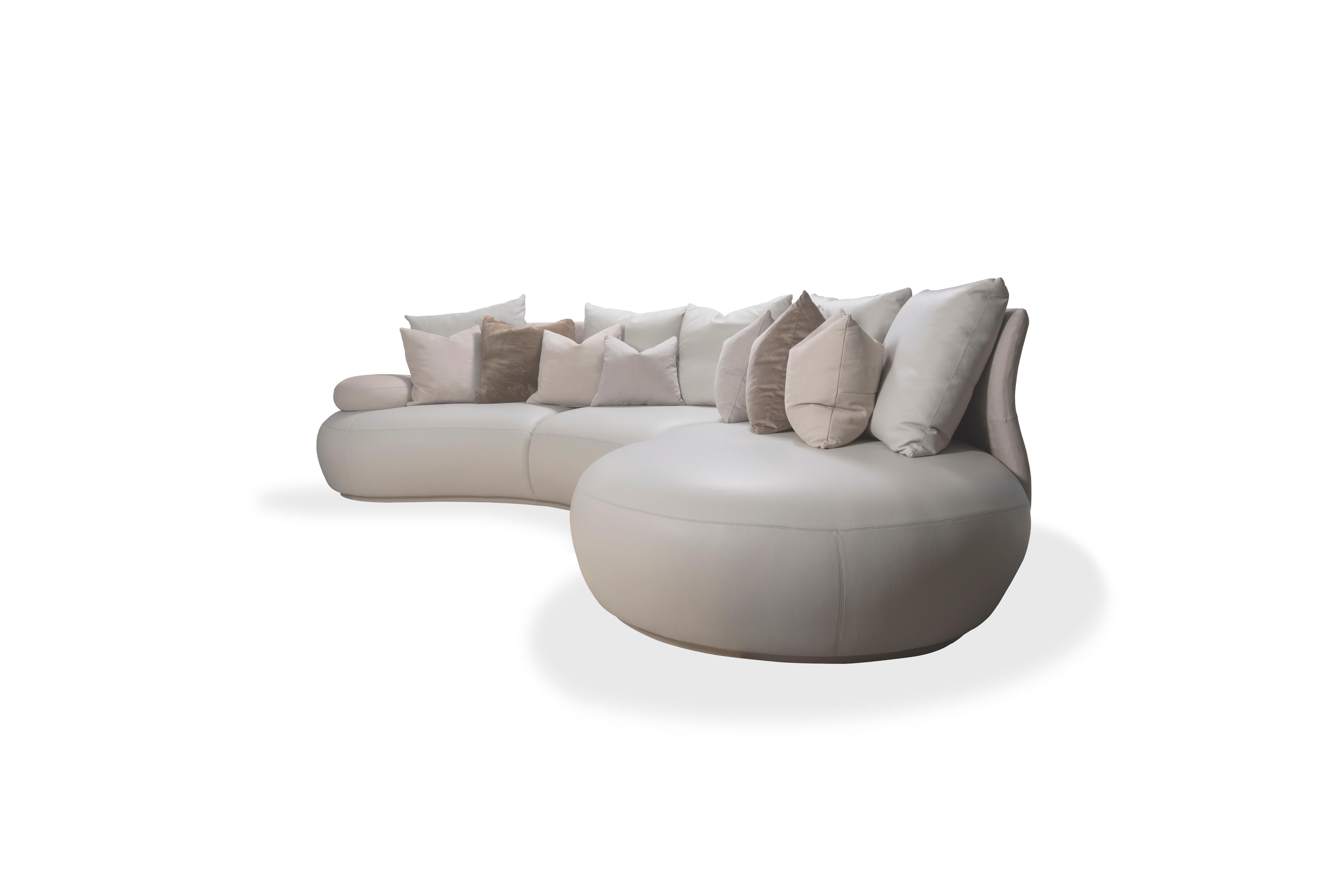 The soft rolling lines following through the entire design of structure and upholstery determine the inviting organic feel of this oversized sofa. The curved back seamlessly transitions into the armrest on one side and into an extensive round chaise