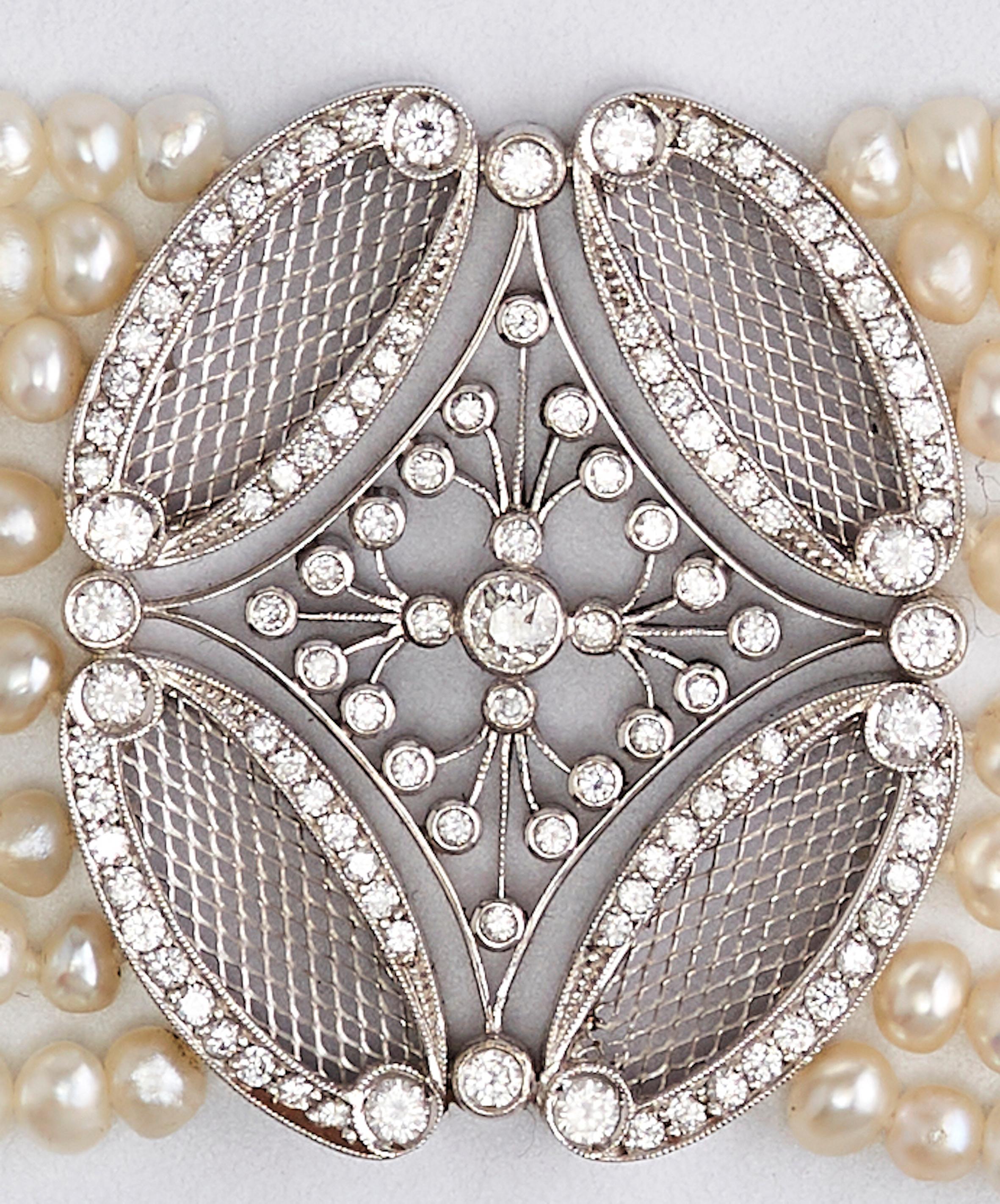 Bahrain Pearls Gold bracelet

Eight rows of gorgeous Bahrain pearls, attached to 5 lines of gold set with diamonds, and in the center of the bracelet a beautiful piece of white gold set with diamonds. 
Art deco from the 1930's in France. Total