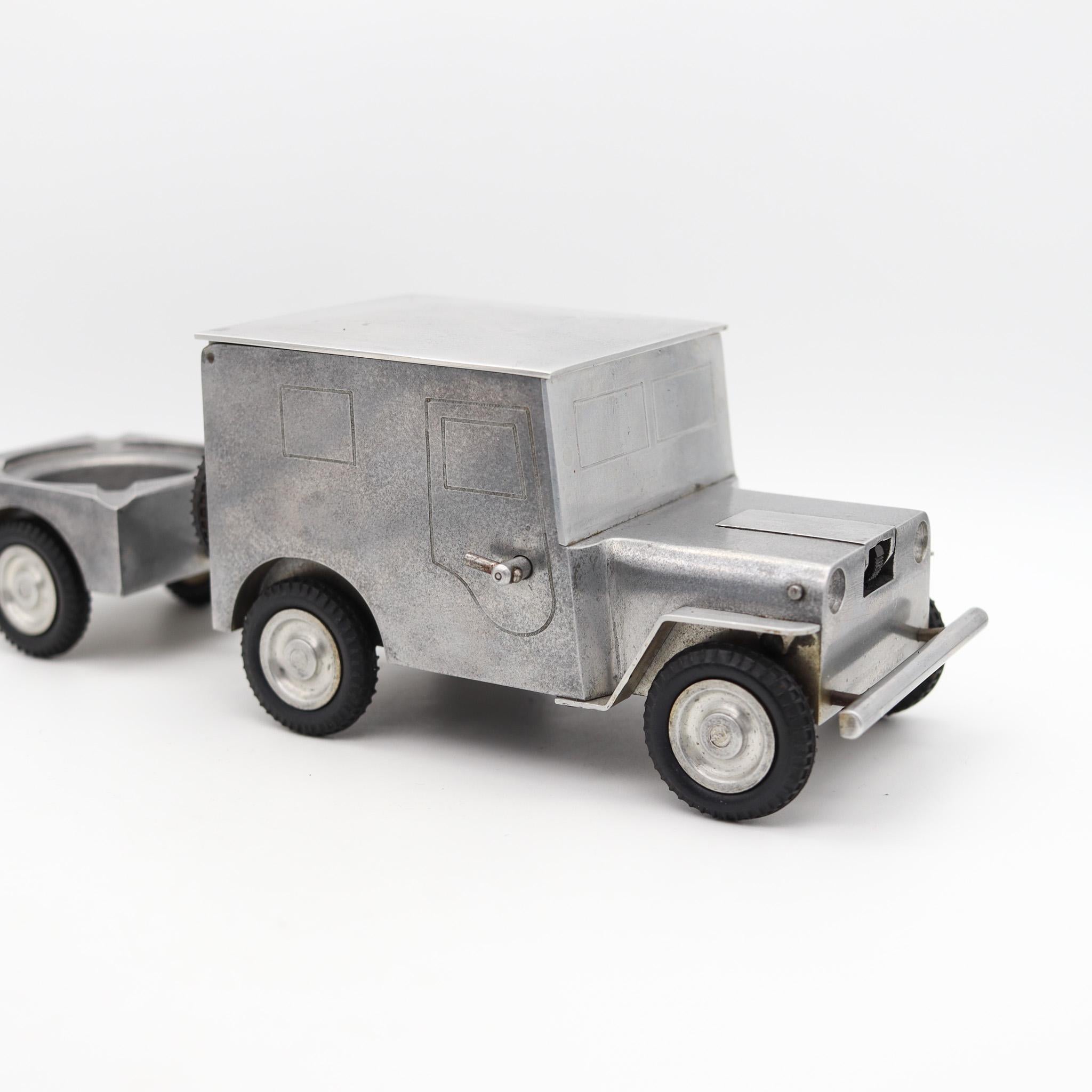 Army Truck Lighter, Cigarette case & ashtray by Walter Baier Company.

Beautiful large sized aluminum lighter by the Baier Company, in the shape of a jeep with a trailer . These wonderful and novel pieces were made very soon after the end of the